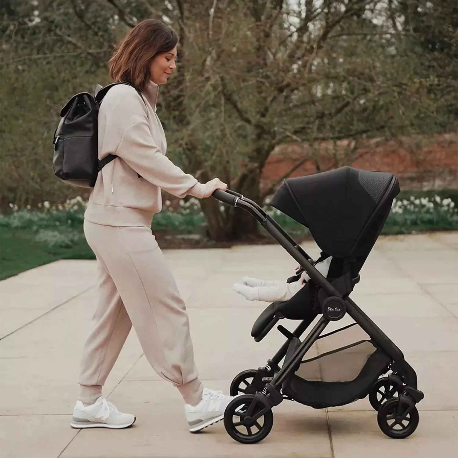 women pushing a black buggy