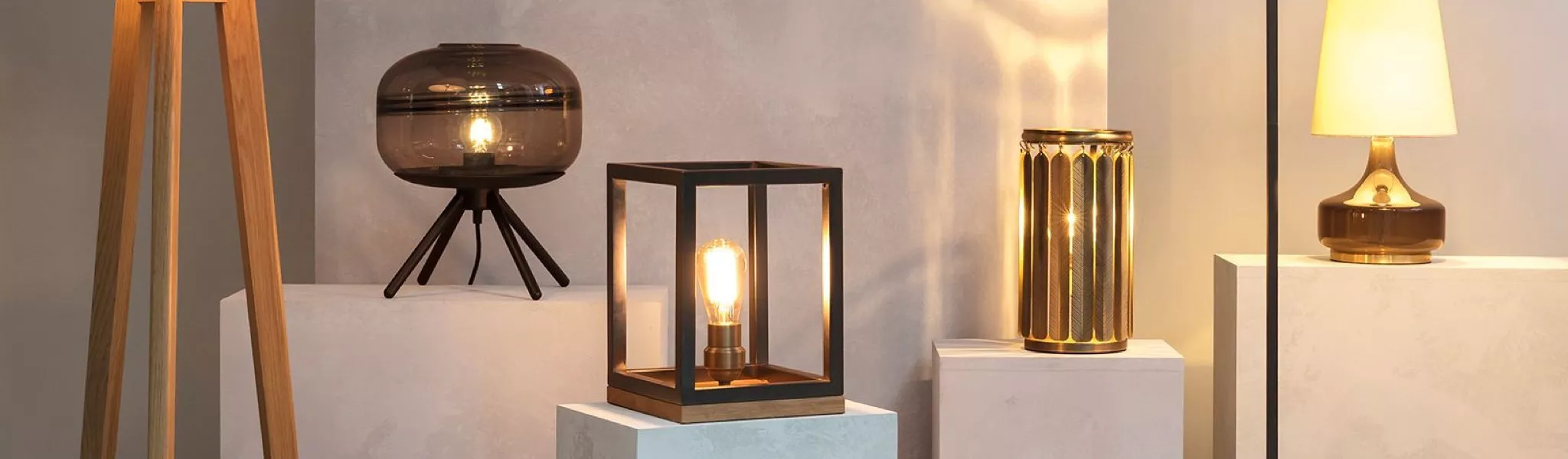 Modern lamps on display, showcasing diverse designs in a warm, ambient light setting.