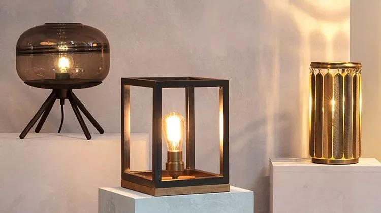 Modern ambient table lamps: smoked glass tripod, cube frame Edison bulb, and gold metal cylinder light