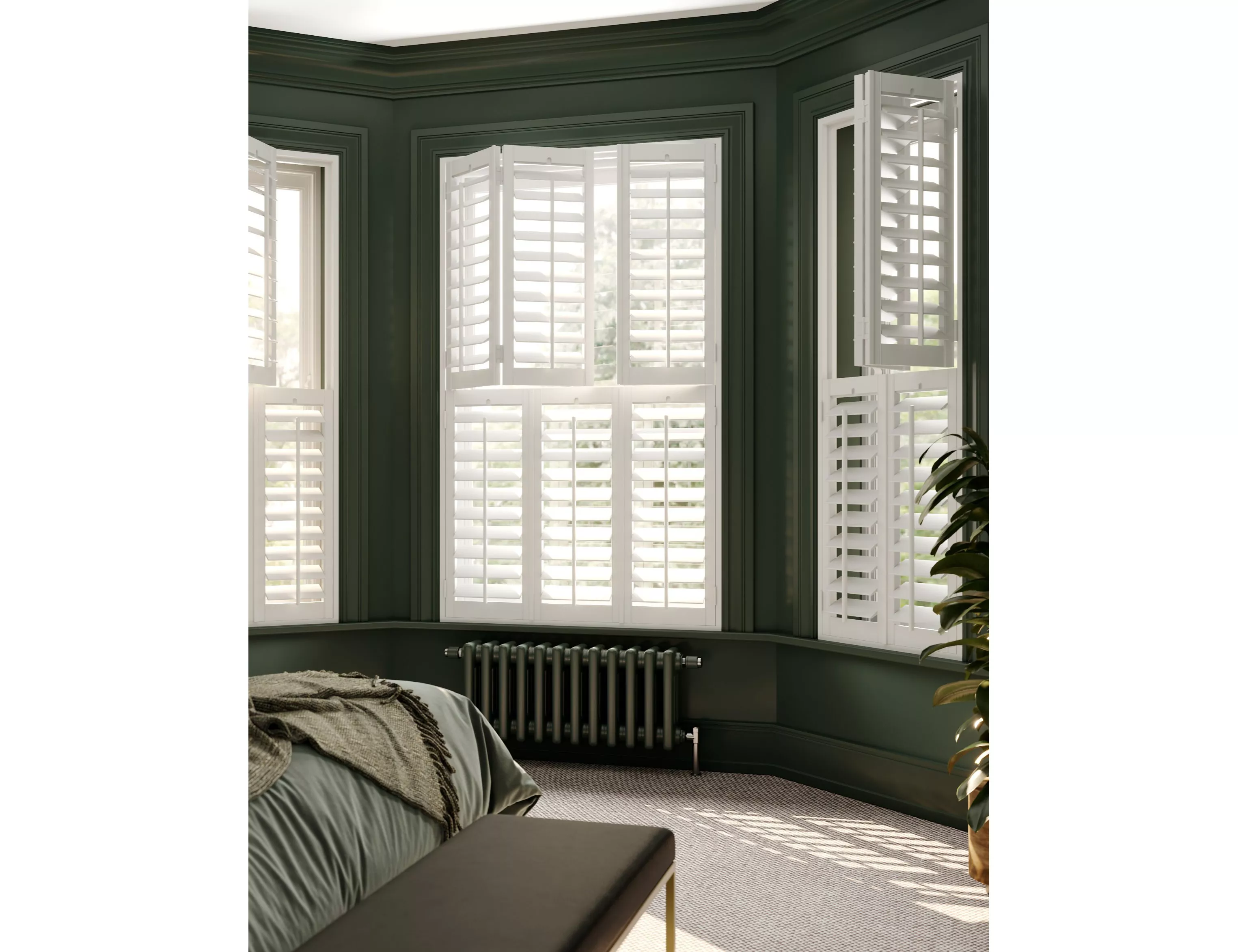 Bay window with white plantation shutters in dark green bedroom, letting in natural light and privacy control
