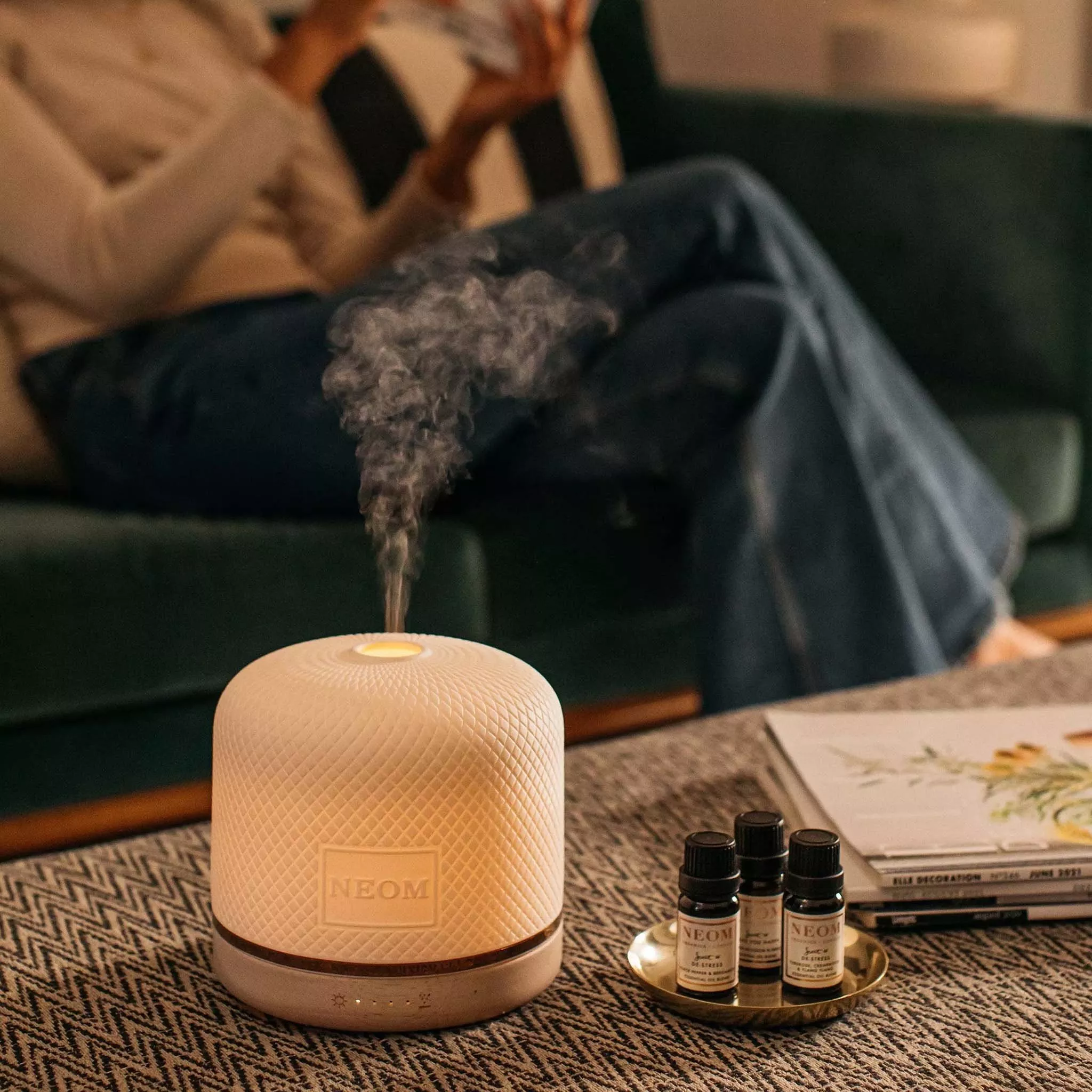 Cream electric diffuser beside diffuser refills