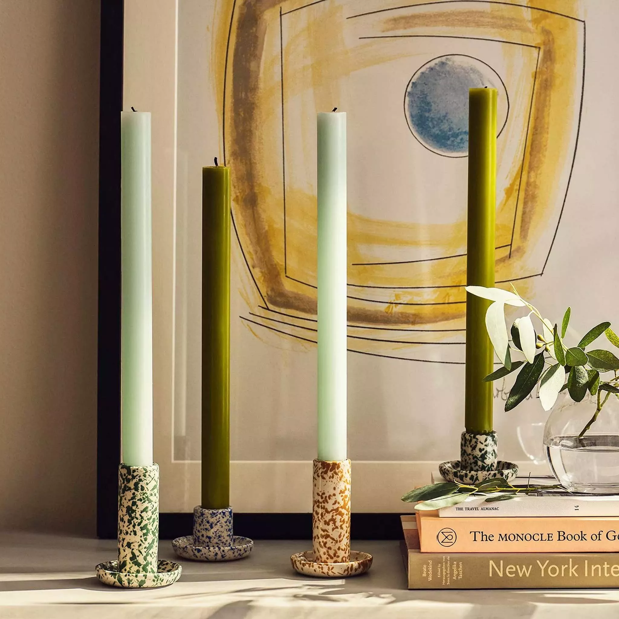 4 candles in candle holders of varying heights