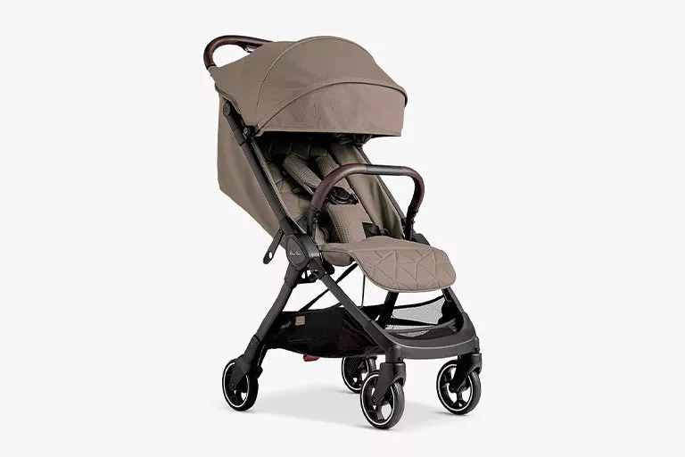 Compact beige stroller with padded seat, adjustable canopy, and swivel wheels. Ideal for convenient urban travel.