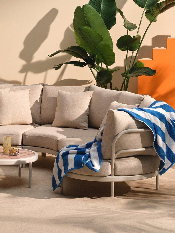 Garden furniture sofa with blue striped towel