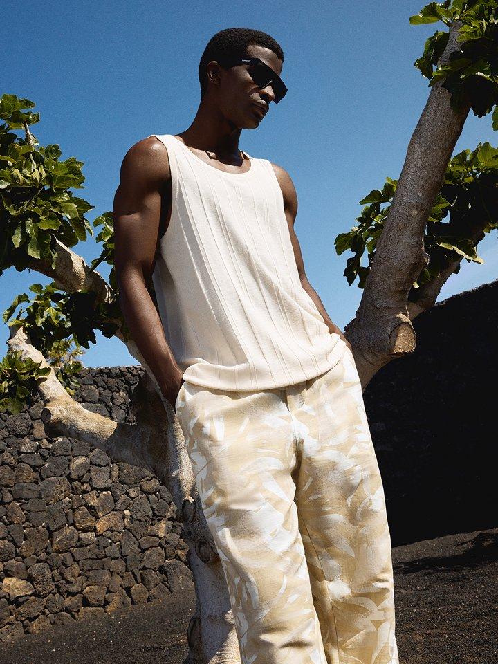Male model wearing a vest and trousers