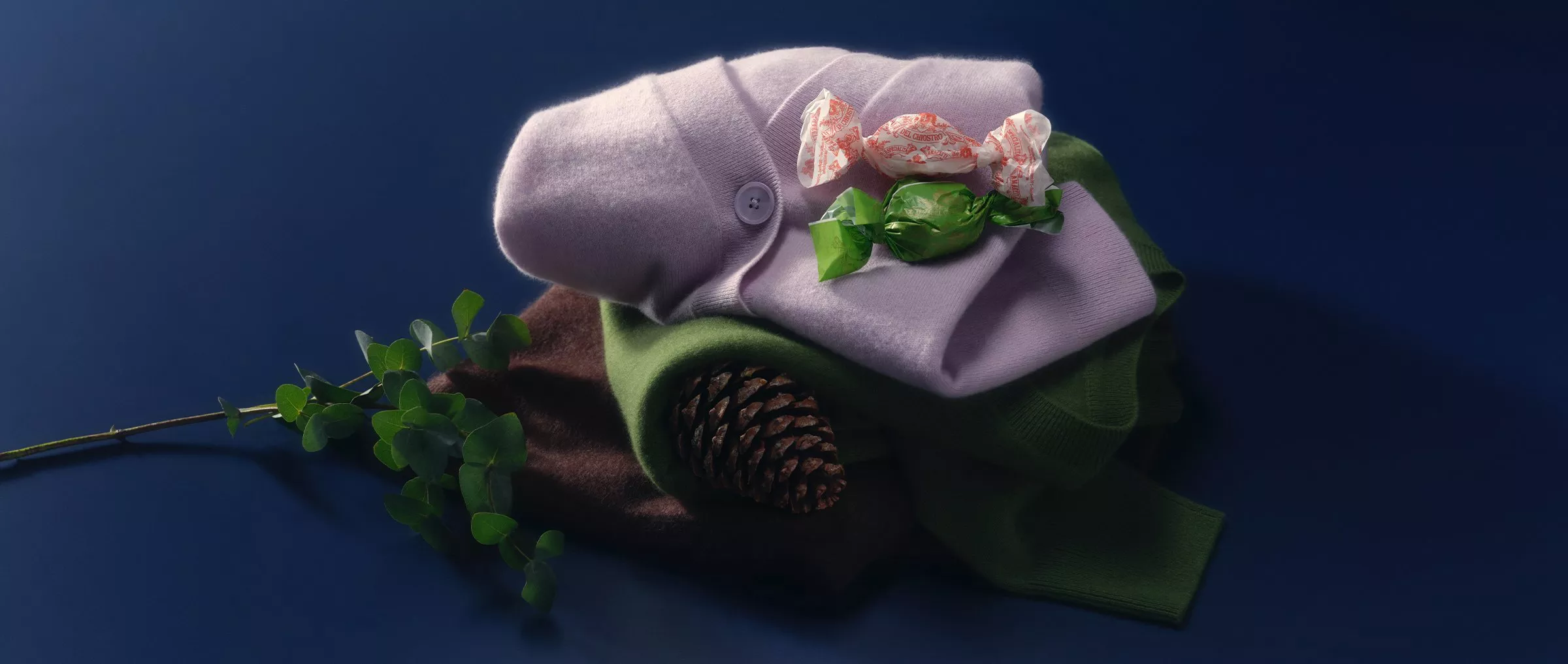 product shot of cashmere jumpers on a navy blue backdrop