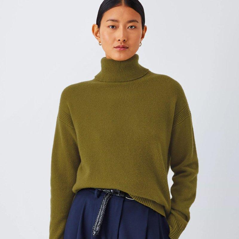 Female model wearing a khaki turtle neck jumper