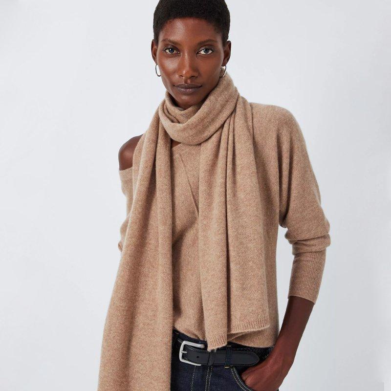 Female model wearing a tan coloured chasmere jumper and matching scarf
