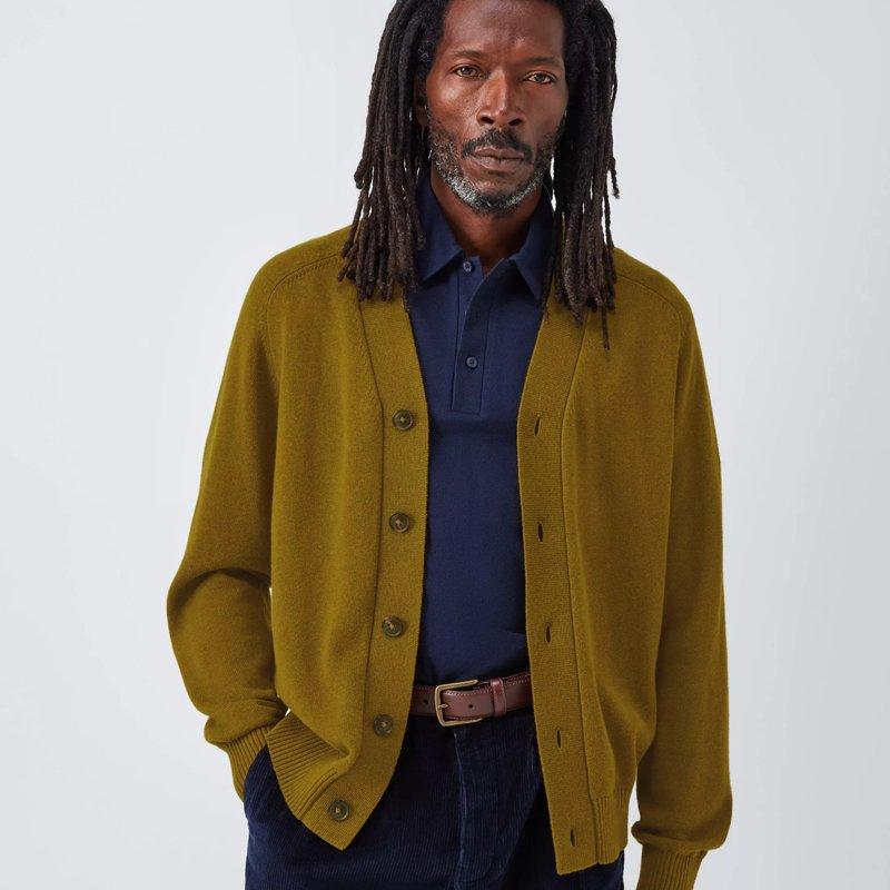 Male model wearing a navy polo with a musk coloured cashmere cardigan