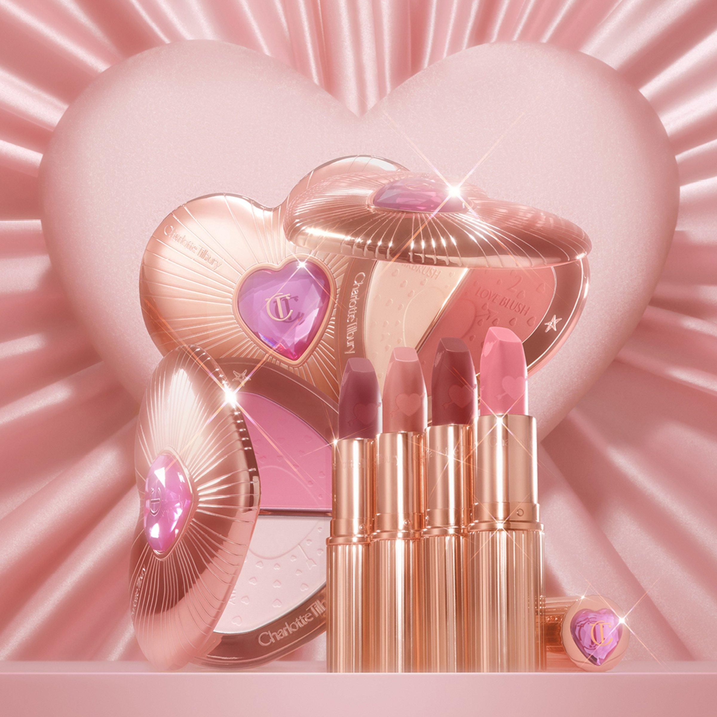 charlotte tilbury cosmetic beauty products with pink heart shape background