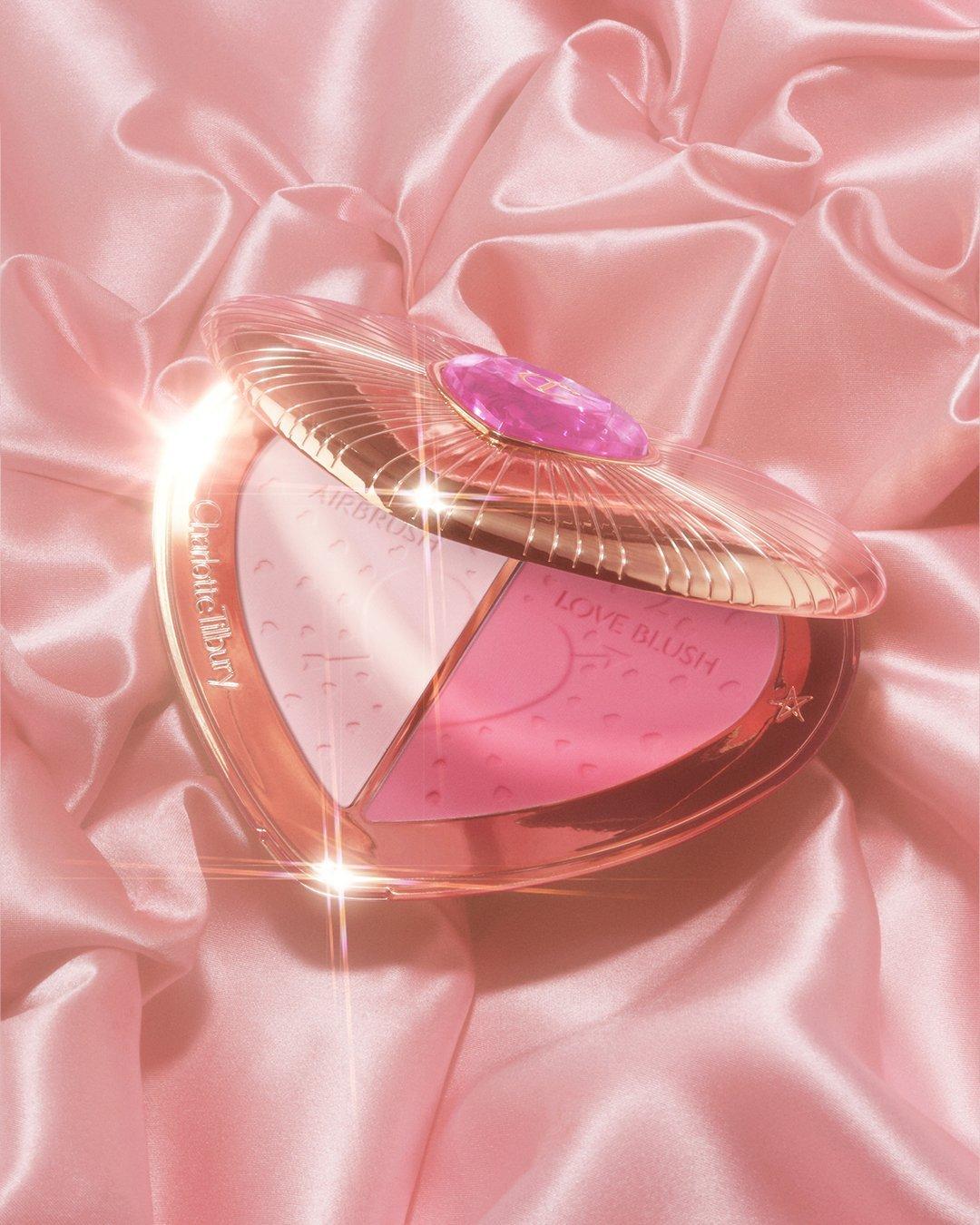 Image of Charlotte Tilbury Face Palettes on a pink silk background