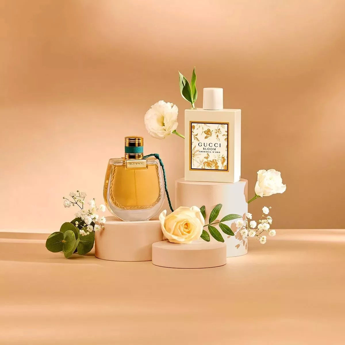 Elegant perfume bottles with floral accents on beige pedestals, highlighting luxury and sophistication.