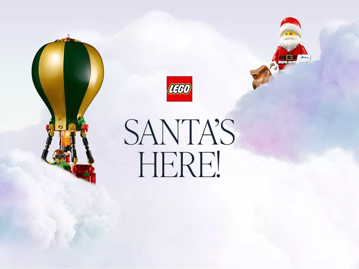 A lego santa and hot air balloon in pastel pink and blue clouds