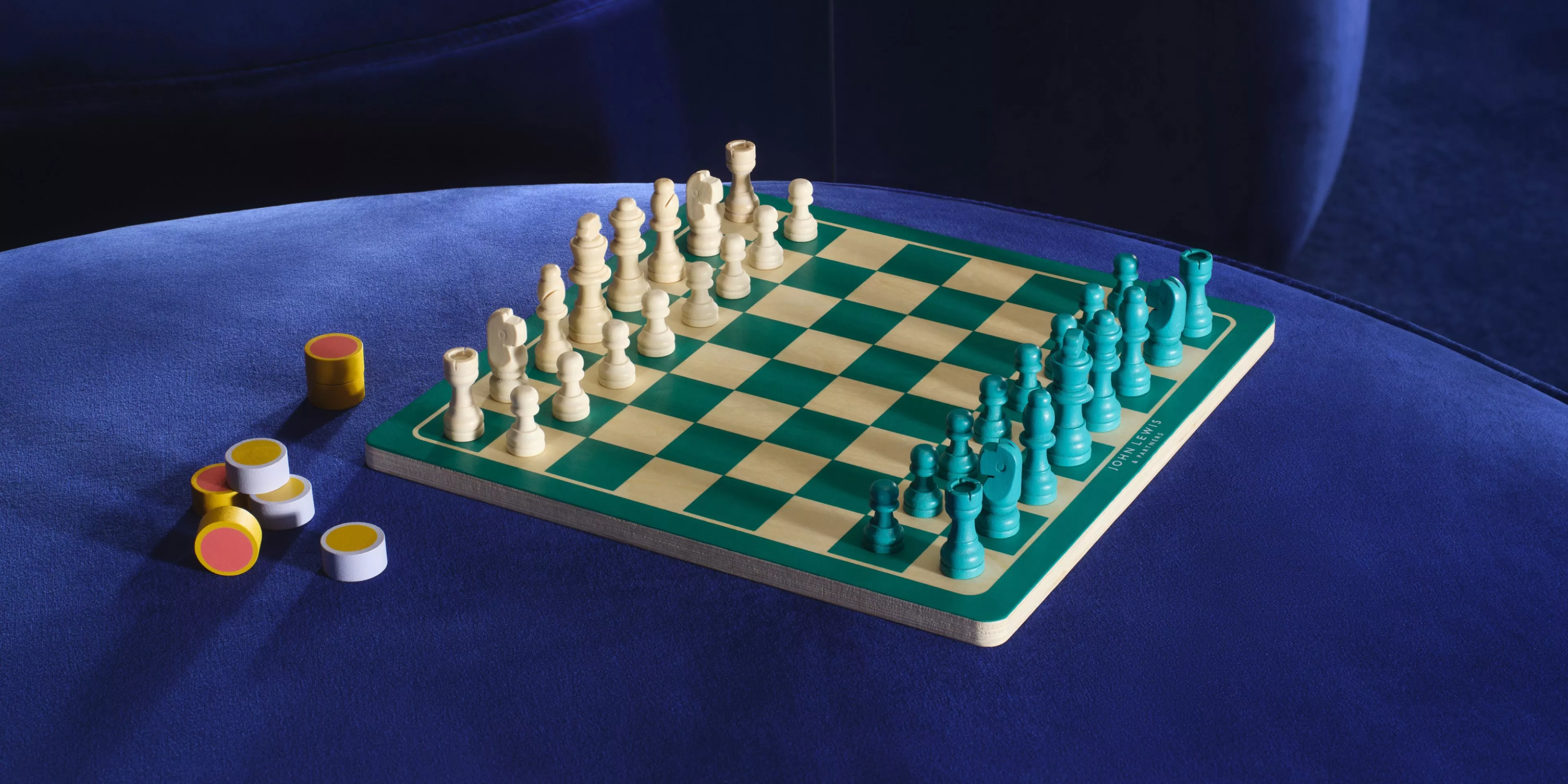 image of a chess board on a blue velvet couch 