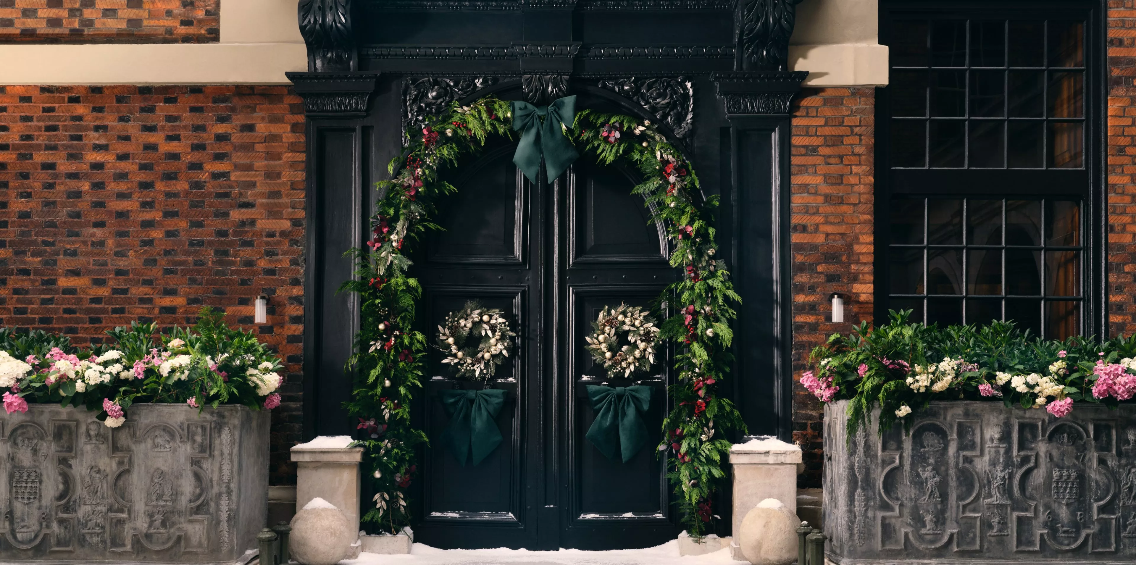 Doorway decorated with Christmas wreaths and garlands