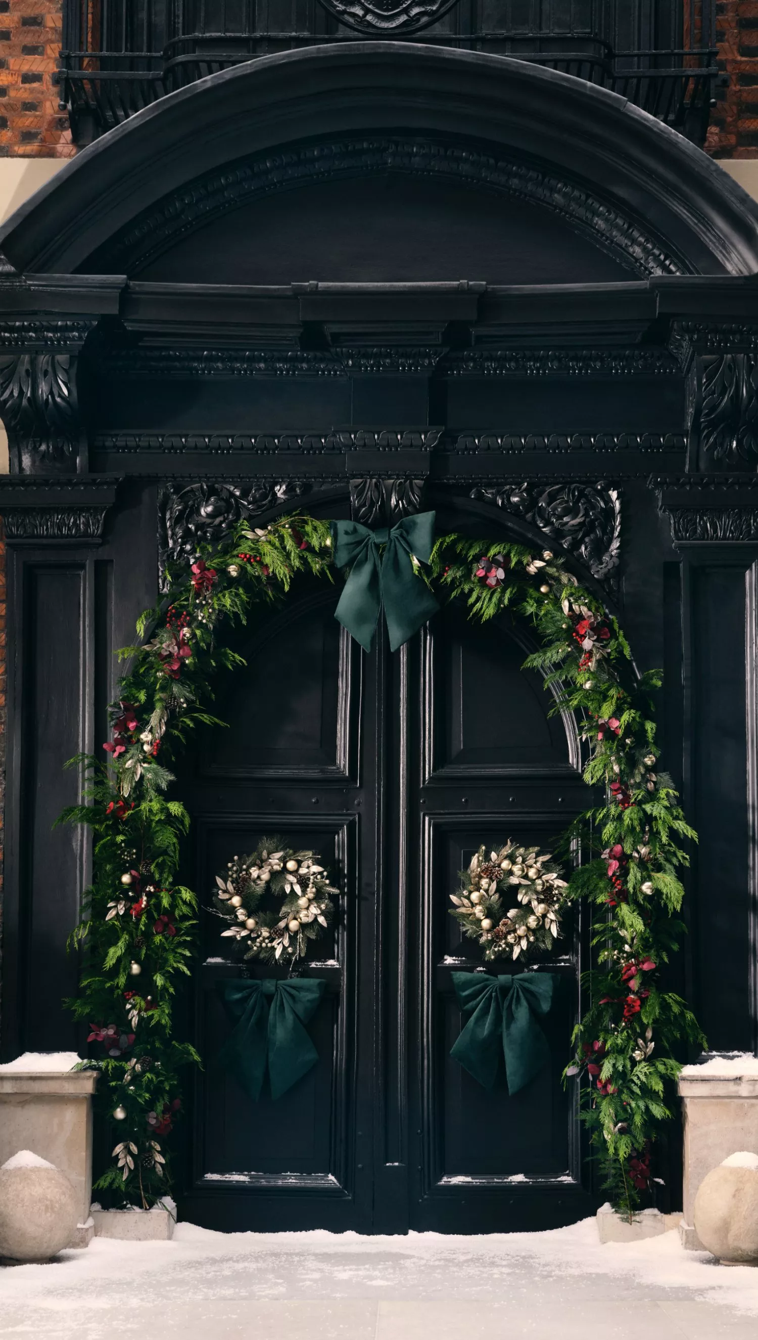 Doorway decorated with Christmas wreaths and garlands
