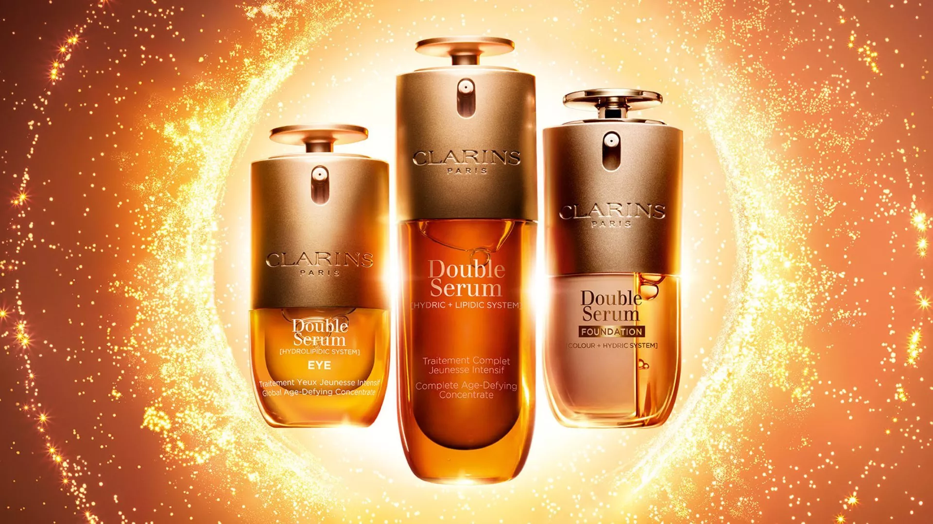 Three bottles of Clarins Double Serum skincare displayed inside a glowing golden ring against a warm amber background.
