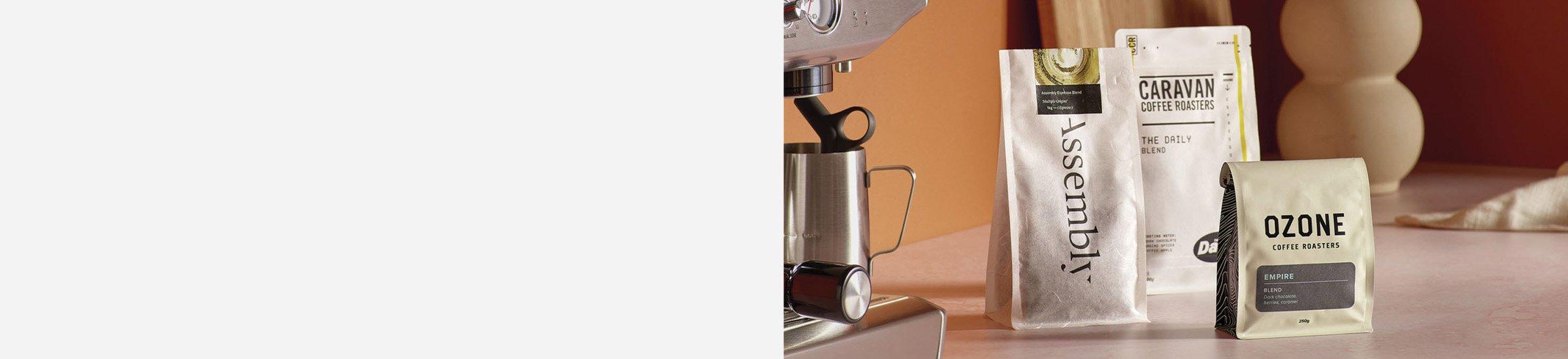 Coffee beans on a counter next to a coffee machine