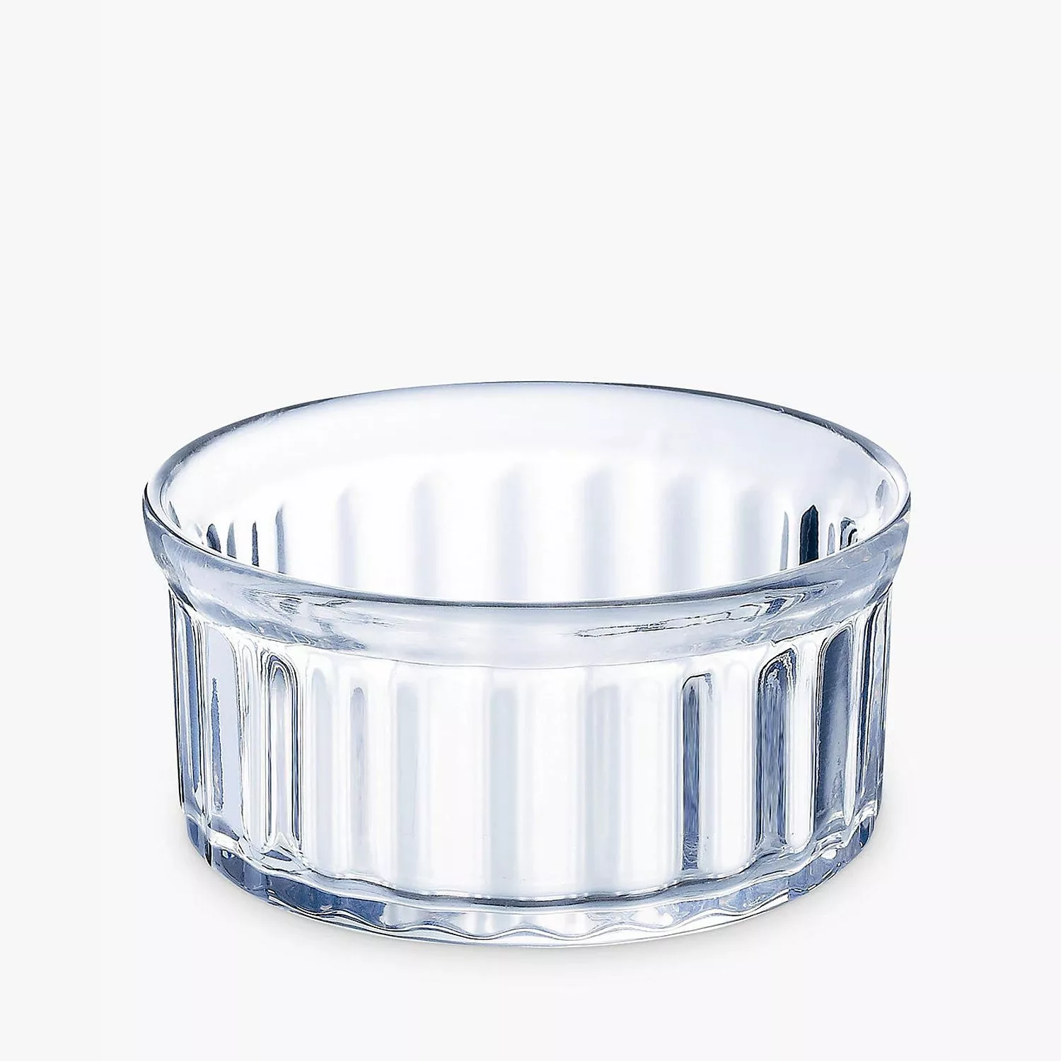Clear ribbed glass ramekin dish for baking soufflés, crème brûlée or serving sauces on a white background