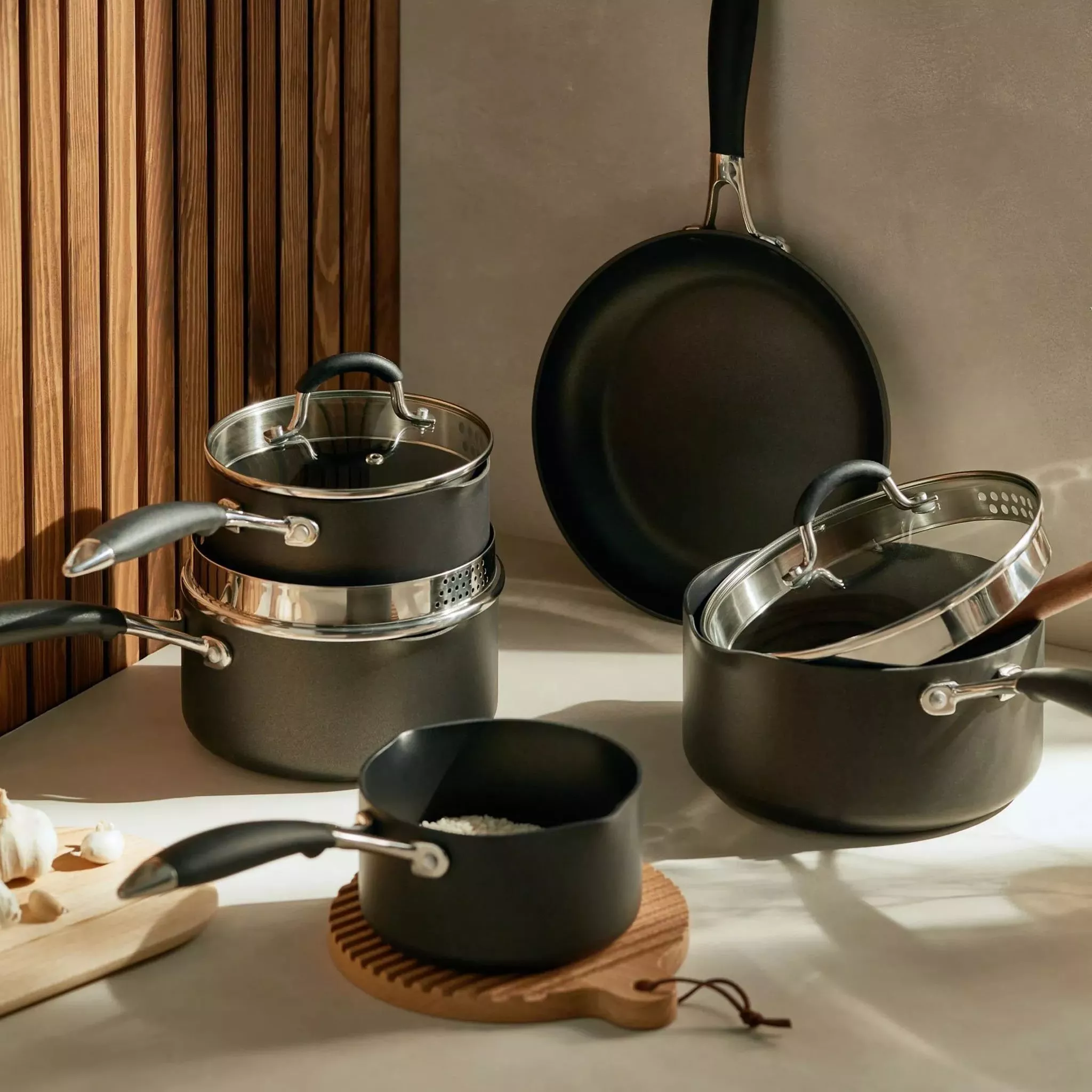 Selection of black pots and pans with silver details