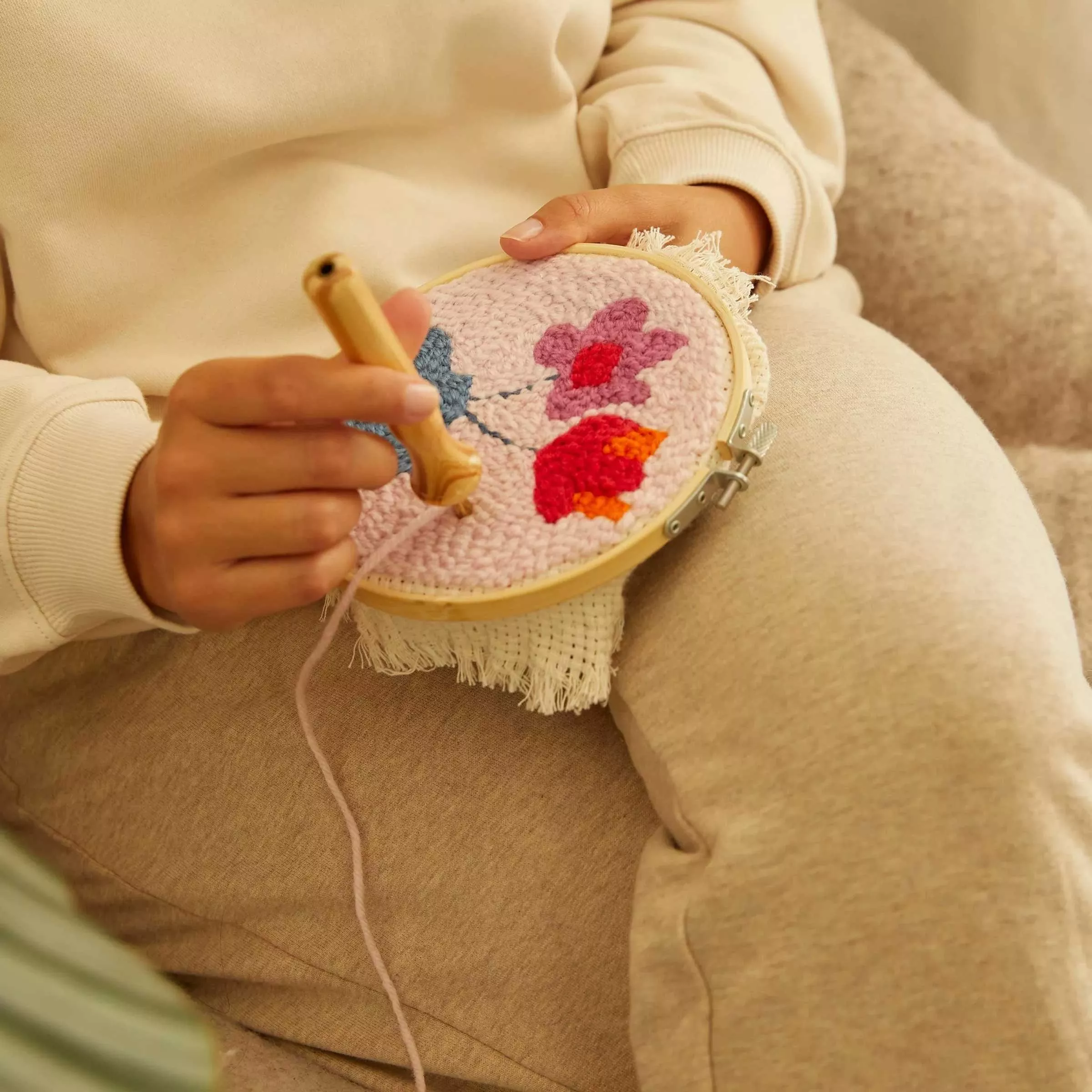 Person crocheting a flower pattern
