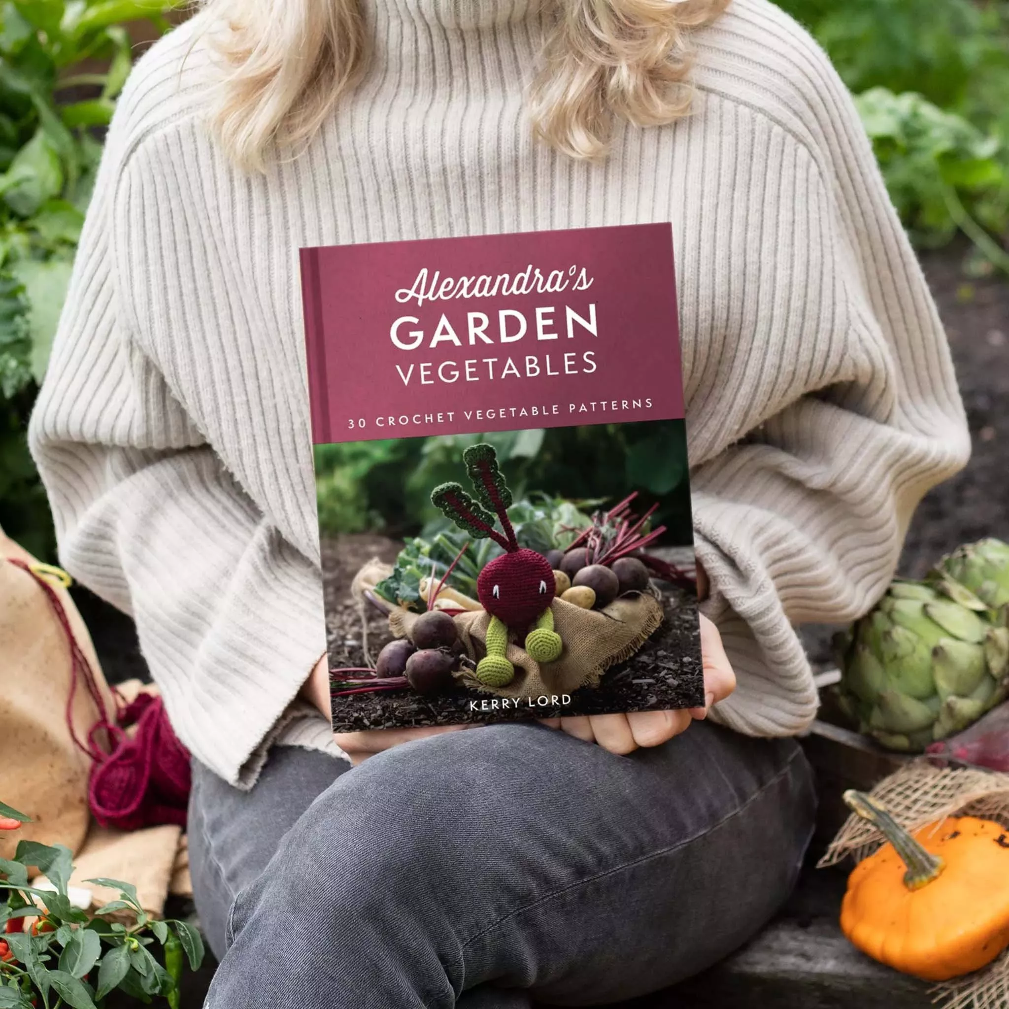 Person holding a book about crochet patterns