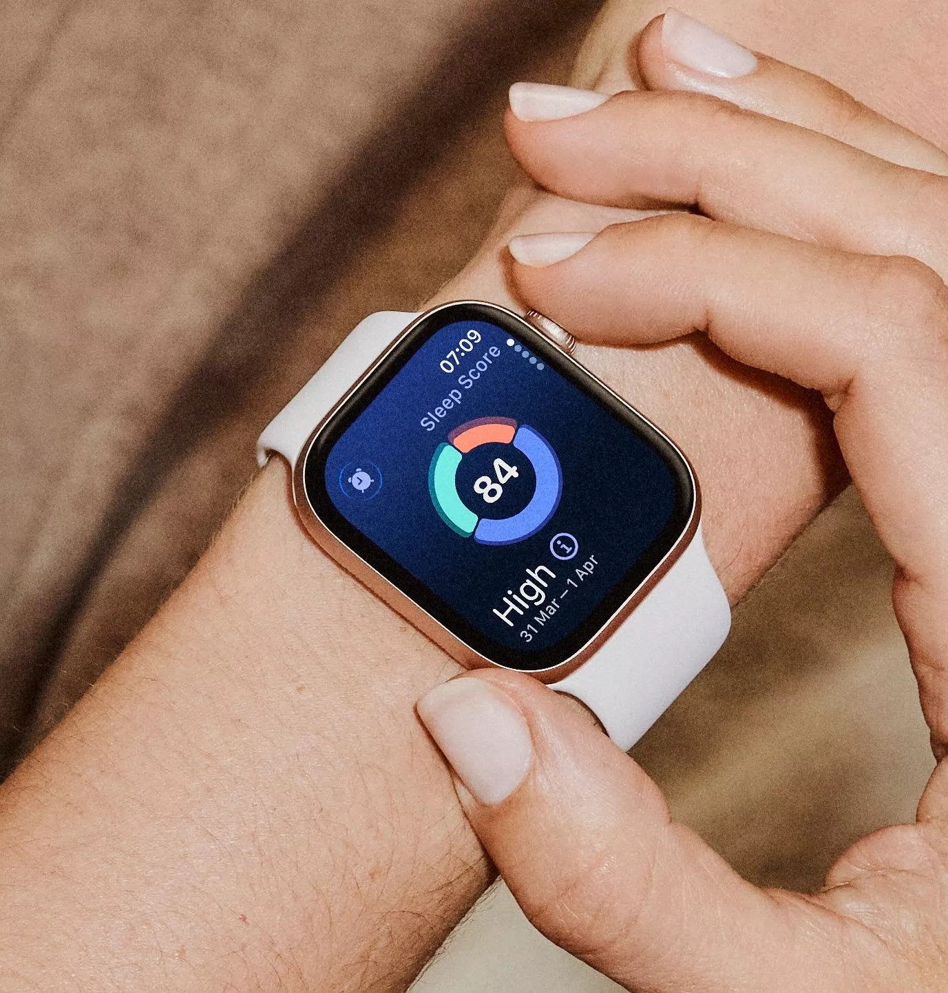 Close-up of smartwatch on wrist showing sleep score 84, health tracking app display and fitness monitoring metrics