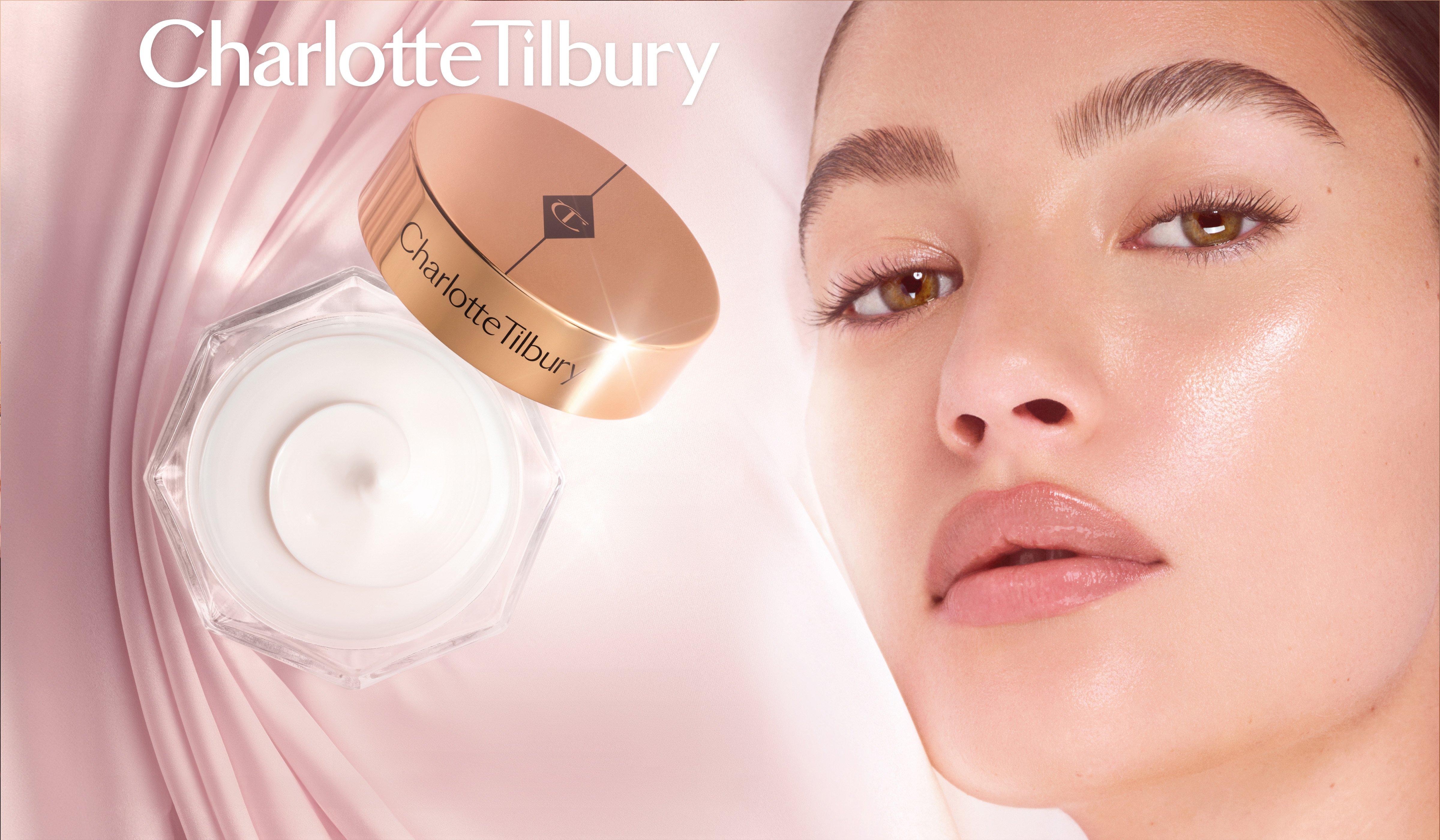 Charlotte Tilbury skincare product next to model's face