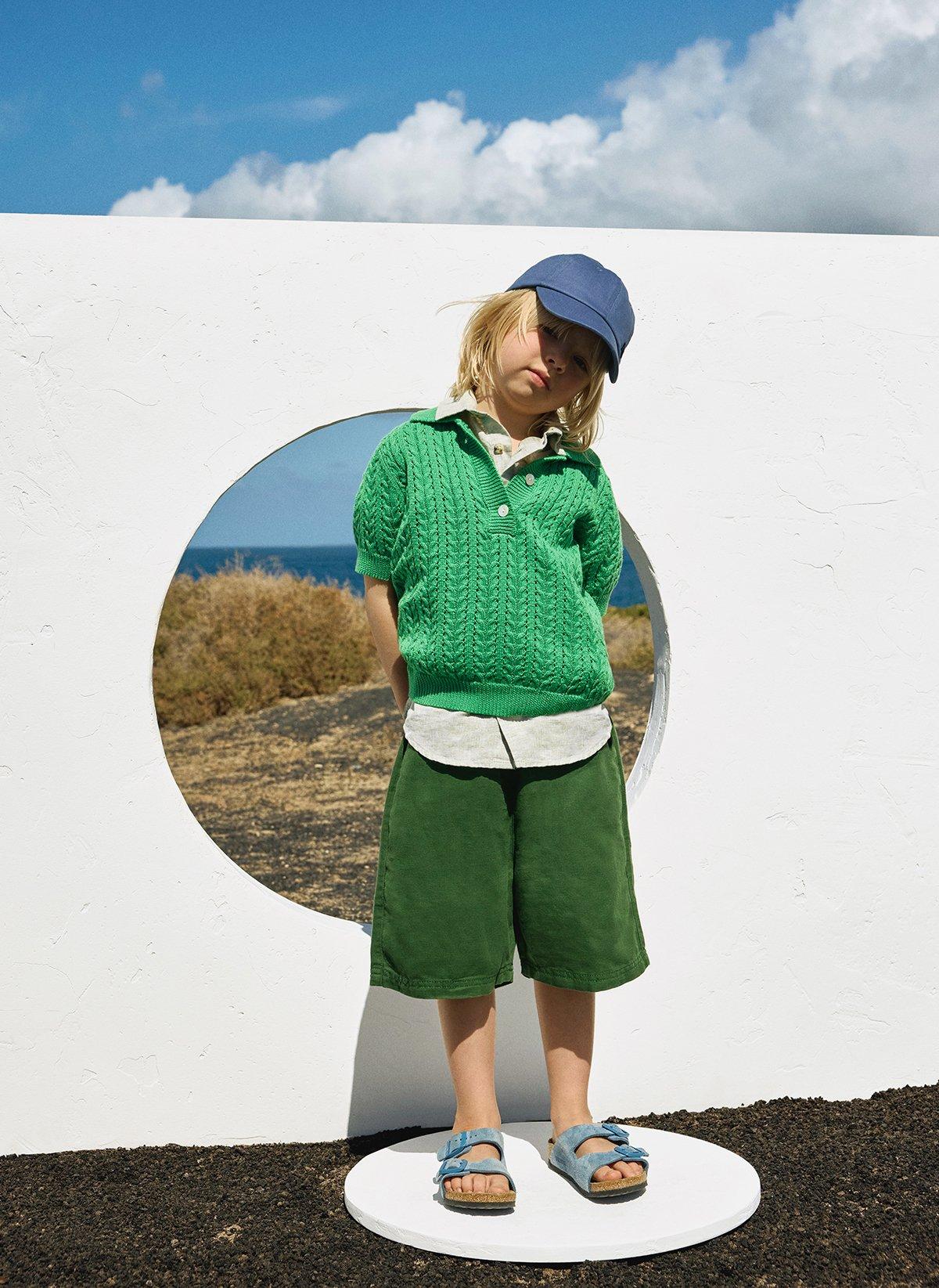 Boy wearing green top and shorts