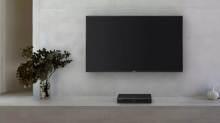 Wall mounted TV with DVD player below it 