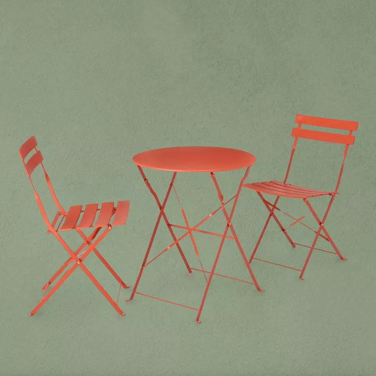 set of orange garden chairs and table 