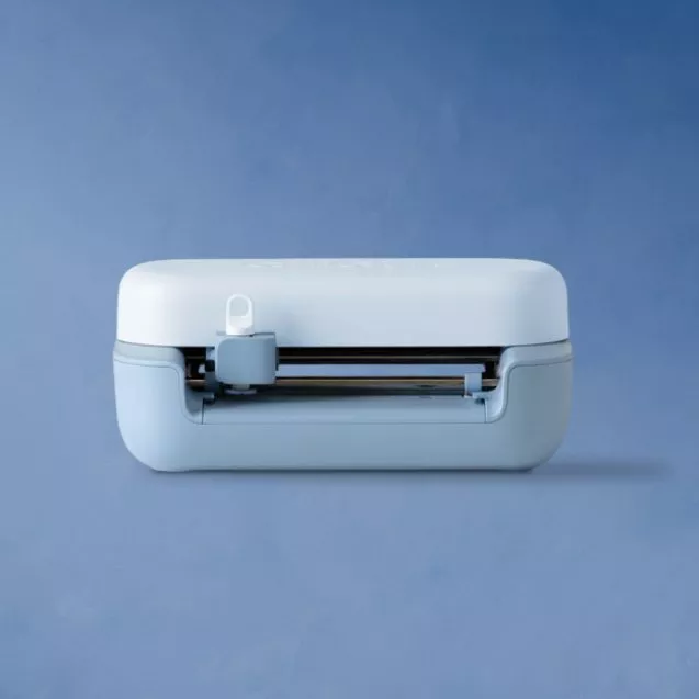 A compact blue and white cutting machine on a blue background, showcasing its sleek design and functionality.