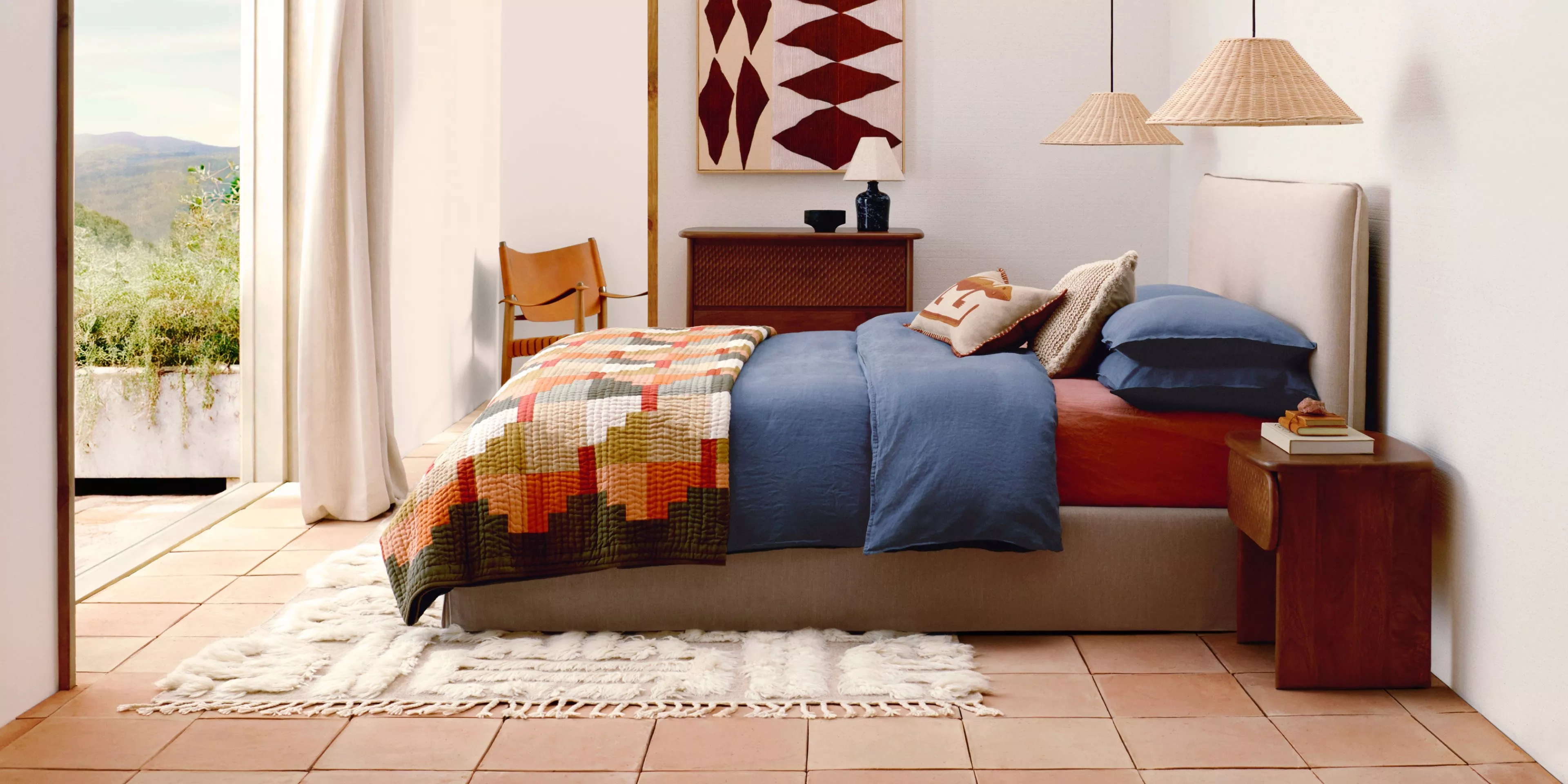 a room with a bed dressed in colourful bohemian style 