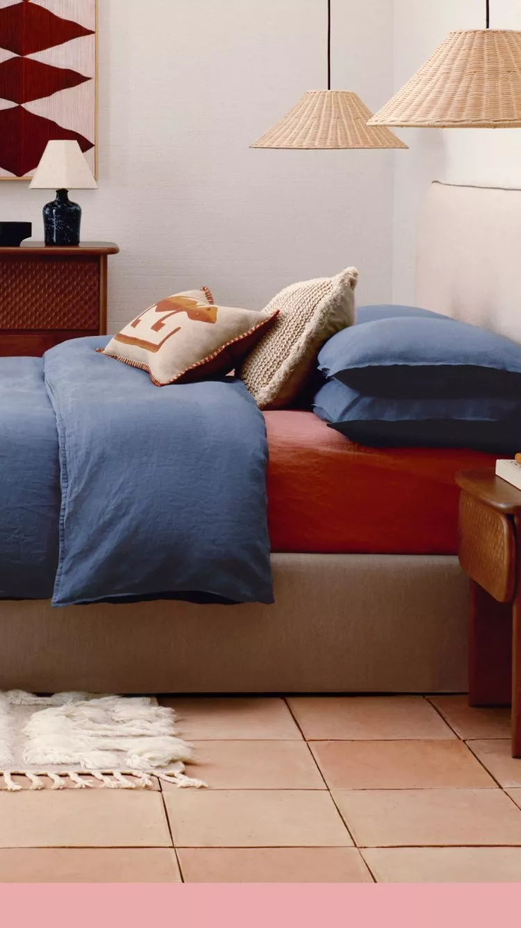 a room with a bed dressed in colourful bohemian style 