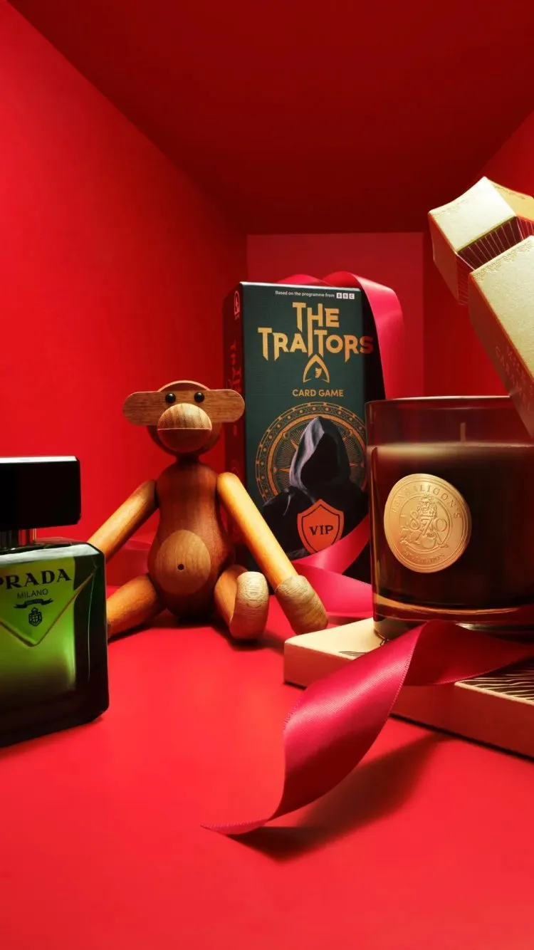 Colourful collectible display: LEGO Darth Vader figure, lava lamp, tapes and red bag on blue backdrop
