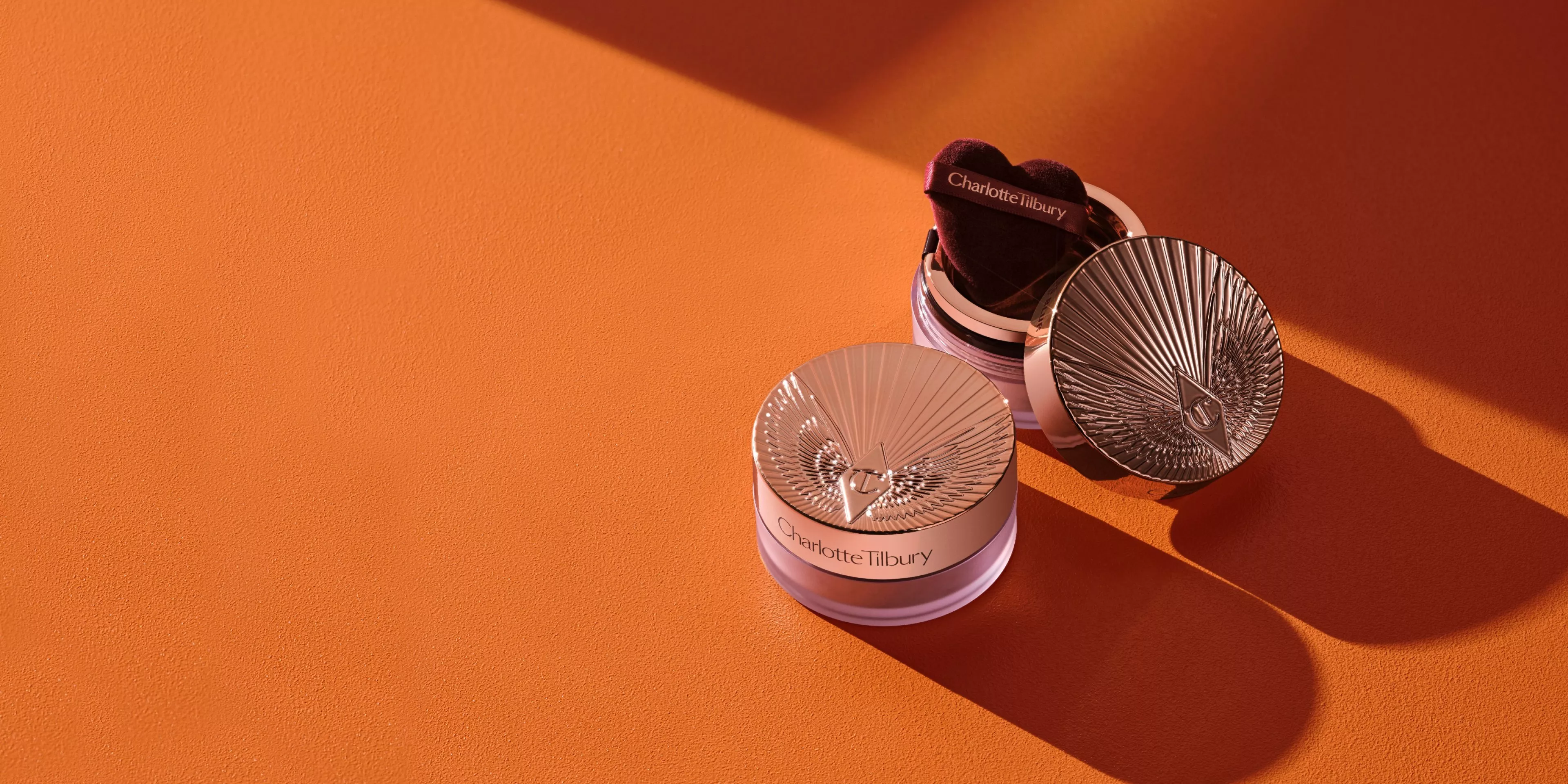 charlotte ilbury products on a orange table