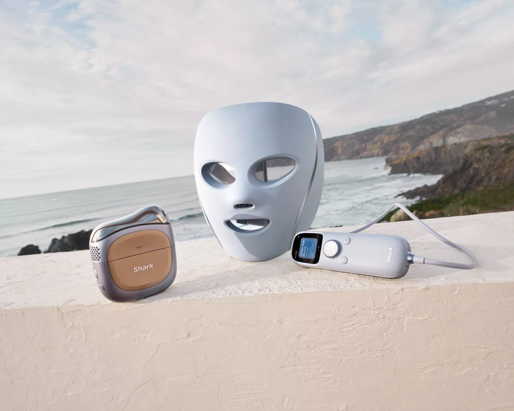 a image of a LED facemask on a concrete wall with a coastal view behind it