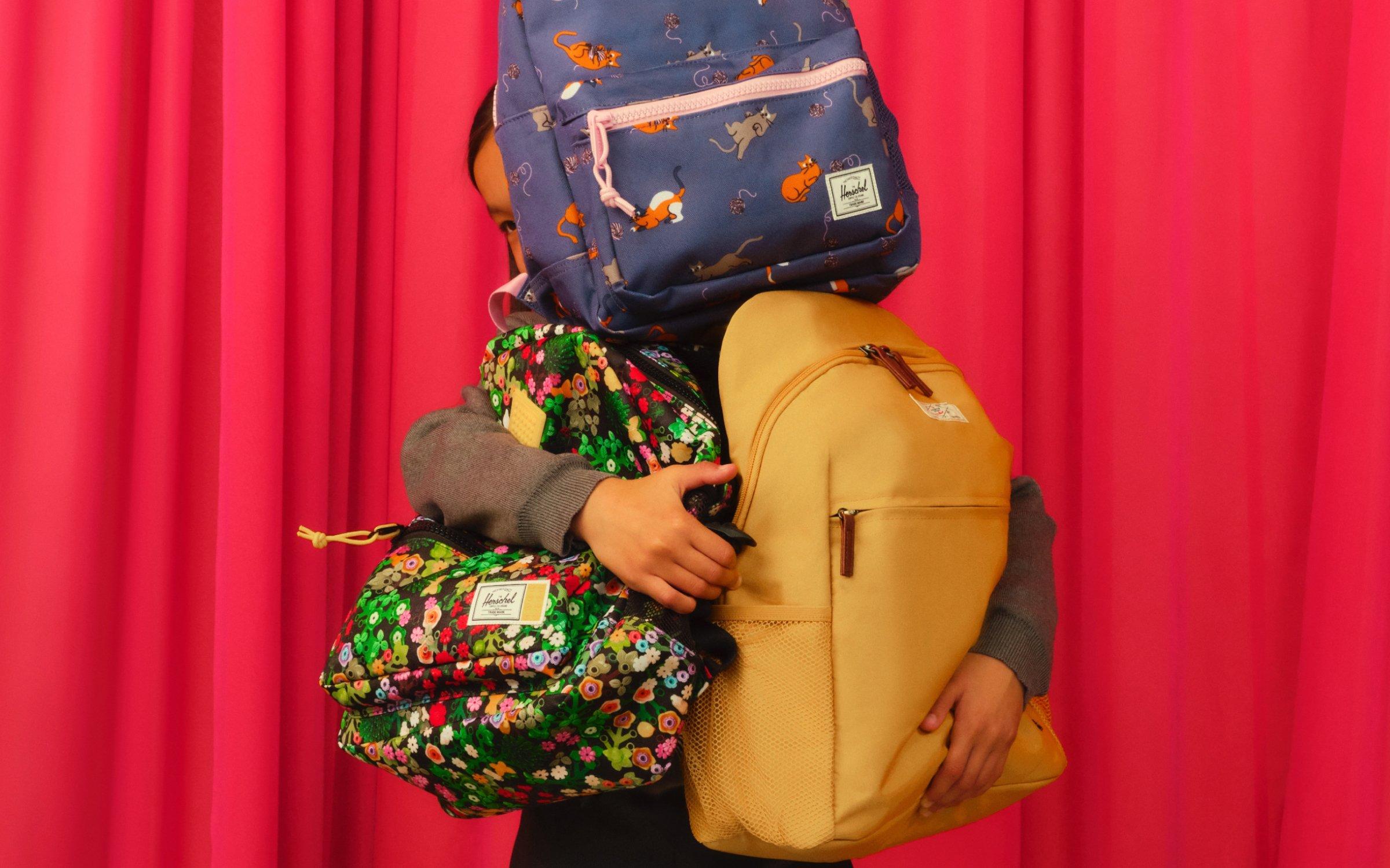 image of a kid holding multiple bags