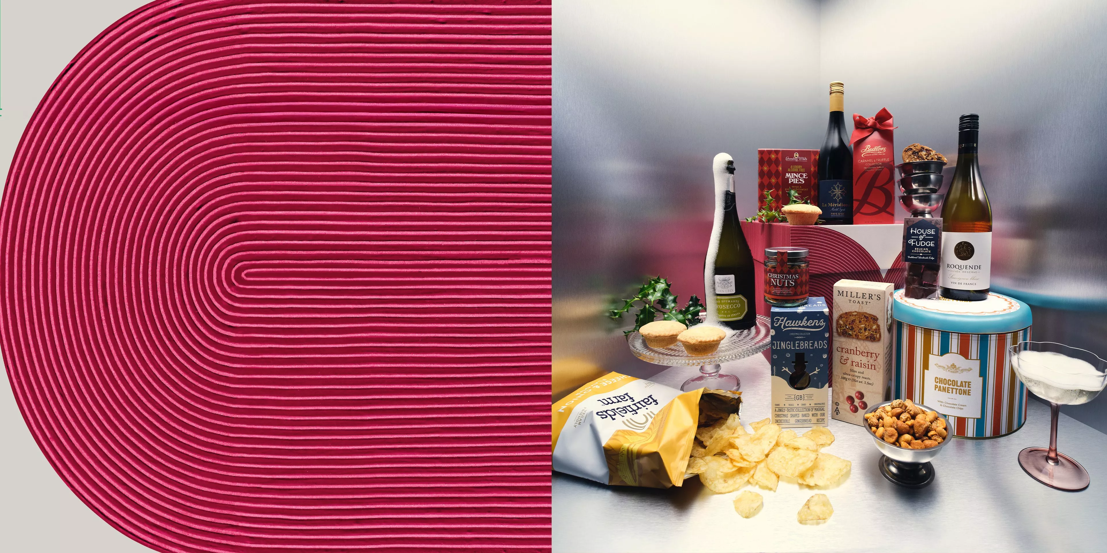 A collection of festive treats and beverages, including a bottle of sparkling wine, boxes of crackers, a tin of panettone