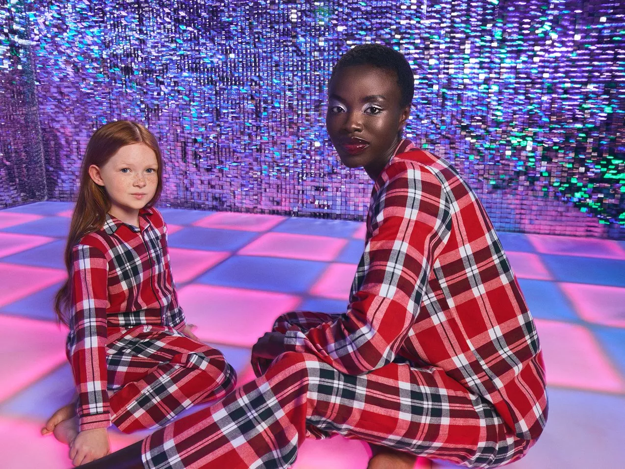 Girl and woman in matching red tartan patterned pyjamas 