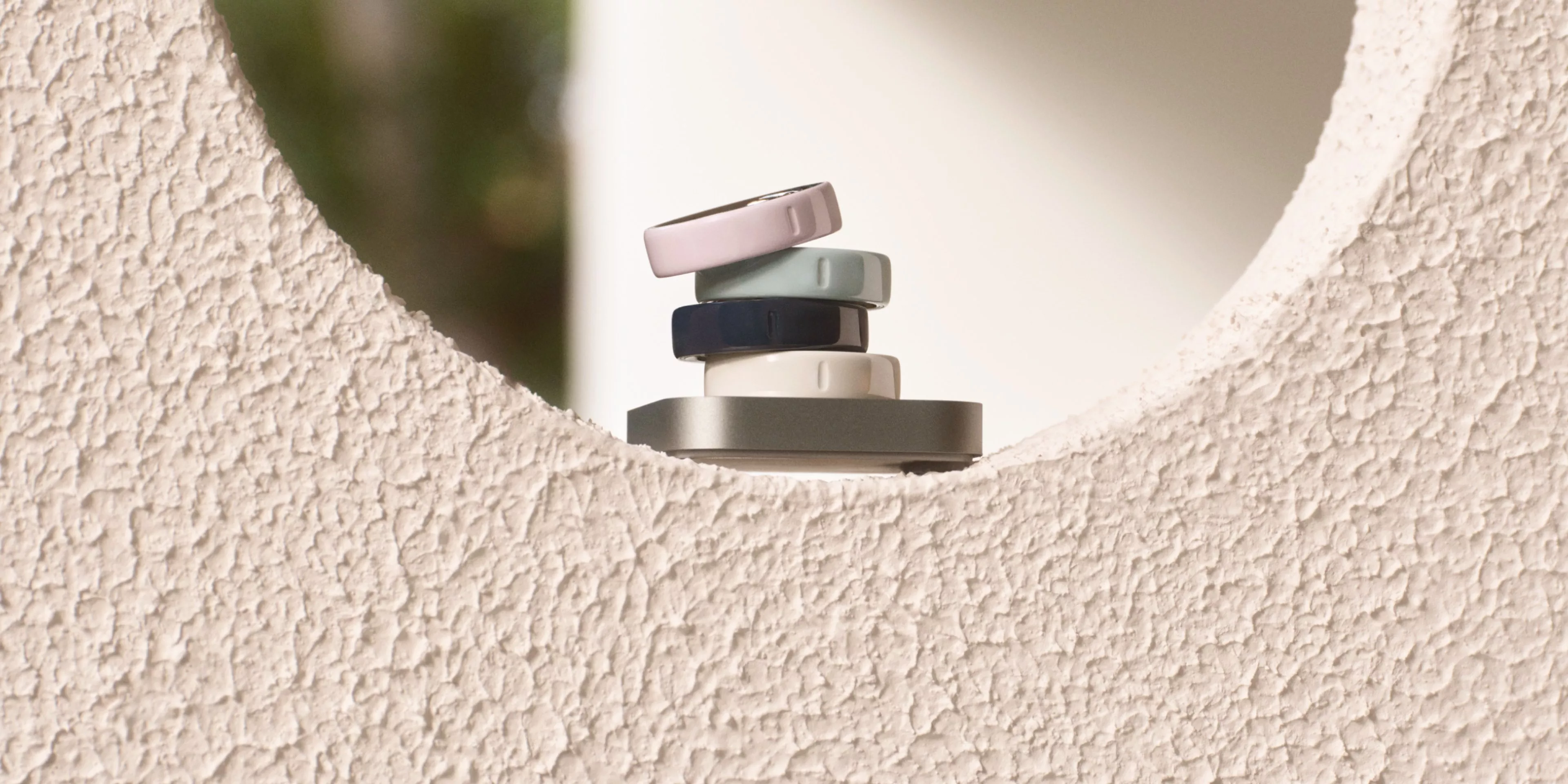 smart rings sitting ontop of a cream wall