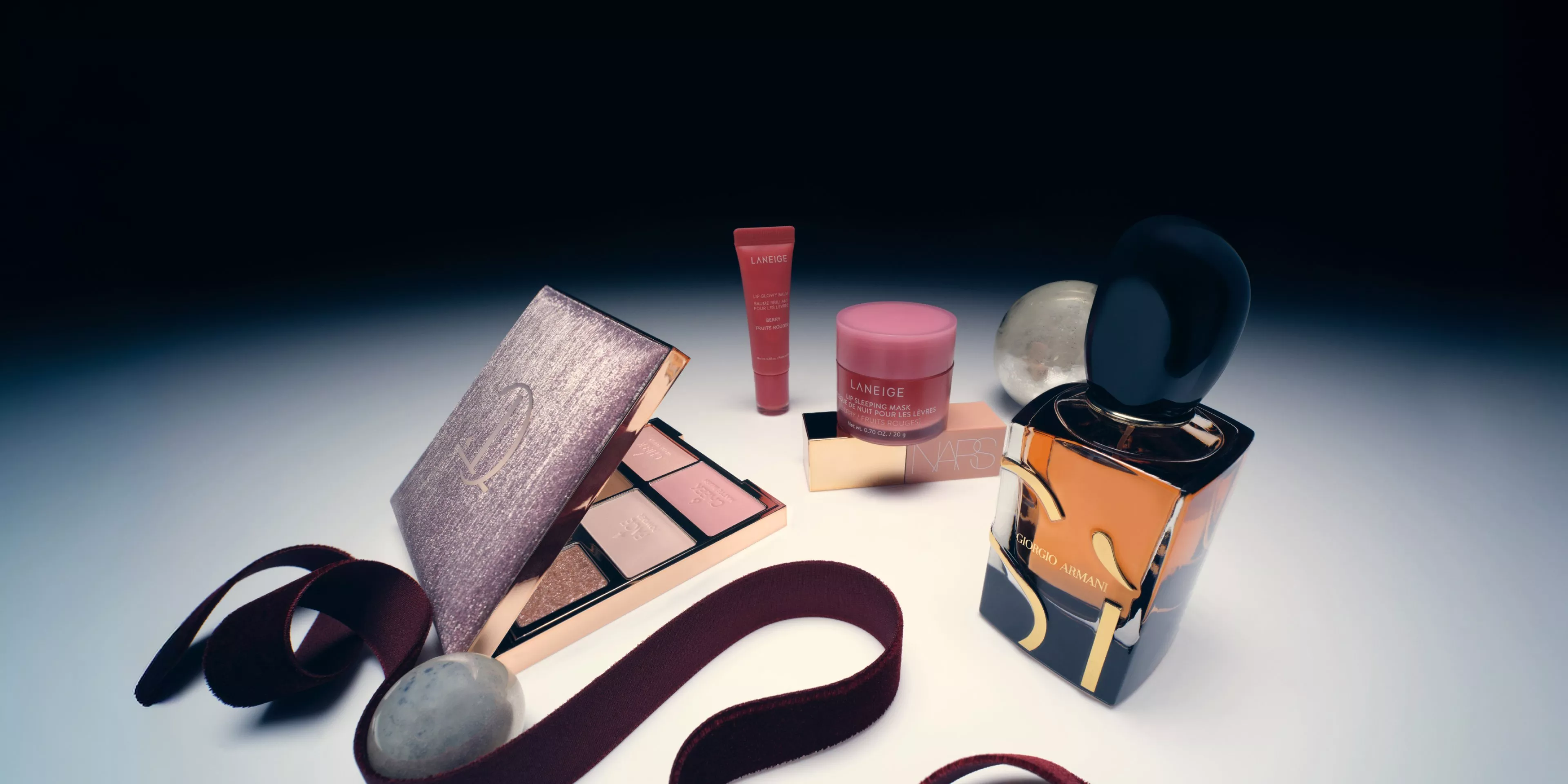 selection of beauty products in a spotlight