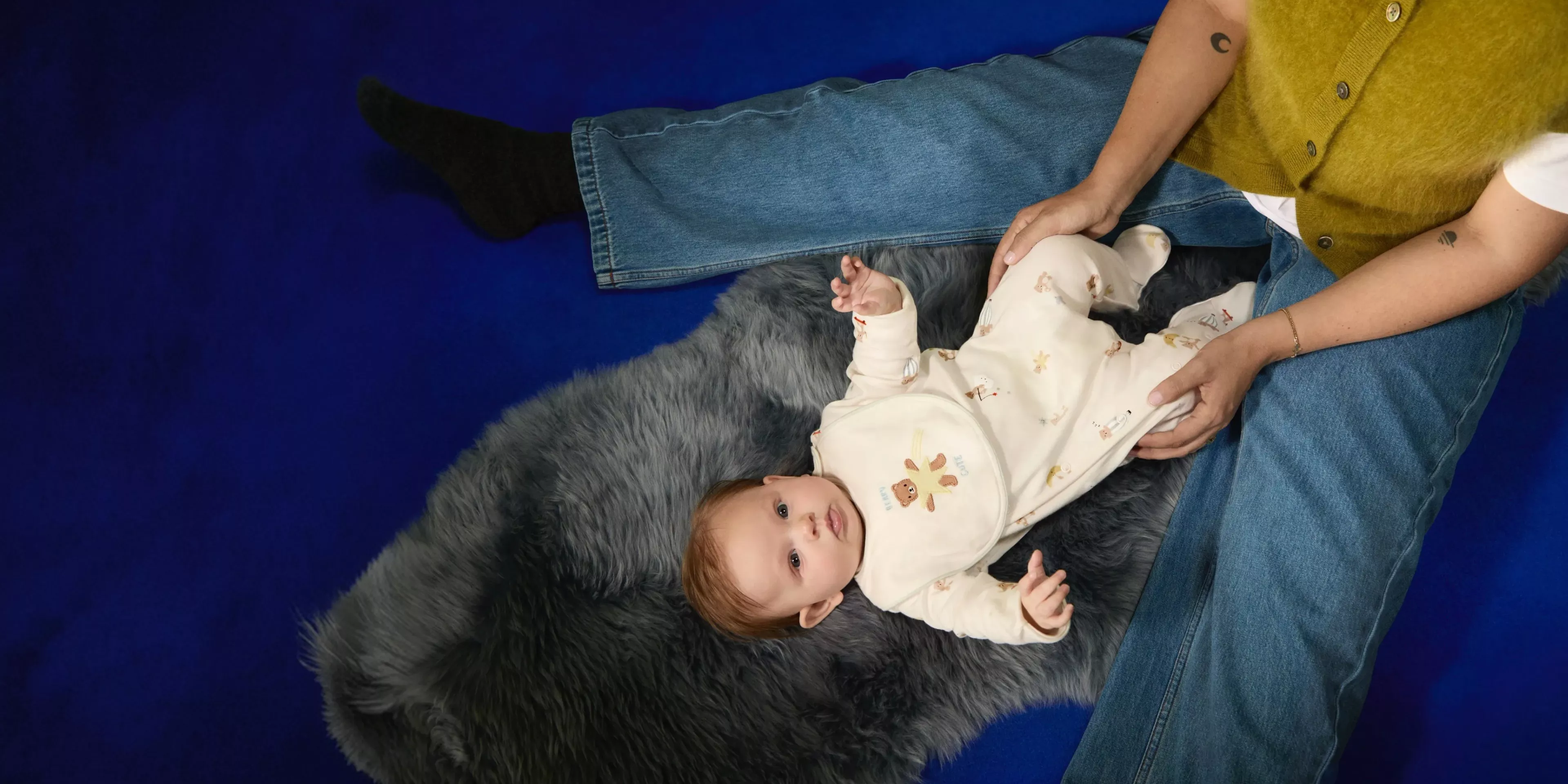 Fashion editorial with model in beige trench coat and another in striped jumper saying mother, indoors by forest view