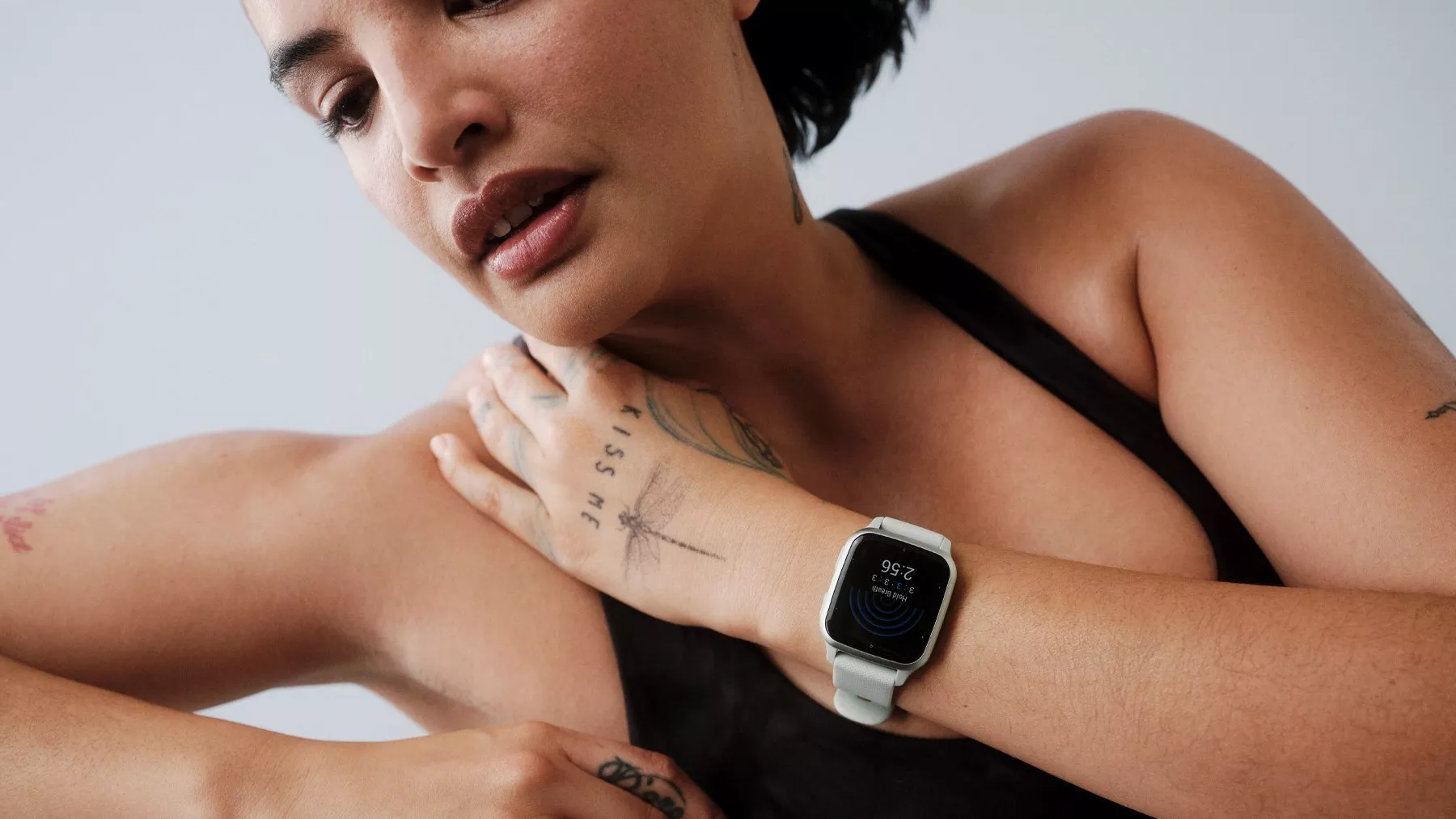 Close-up of woman wearing a smartwatch with fitness tracking display, showcasing wearable tech and active lifestyle