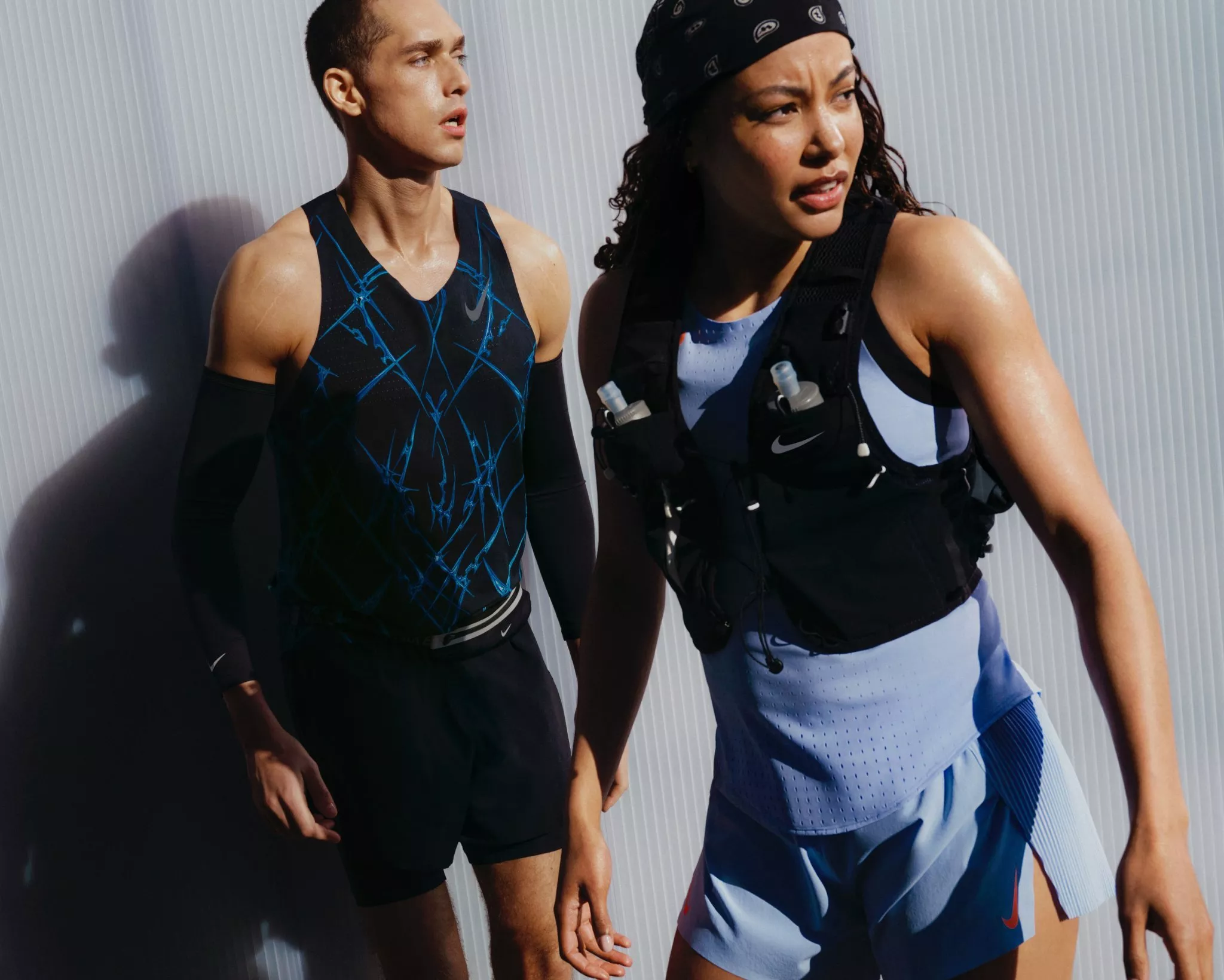 women and man wearing nike sports clothes