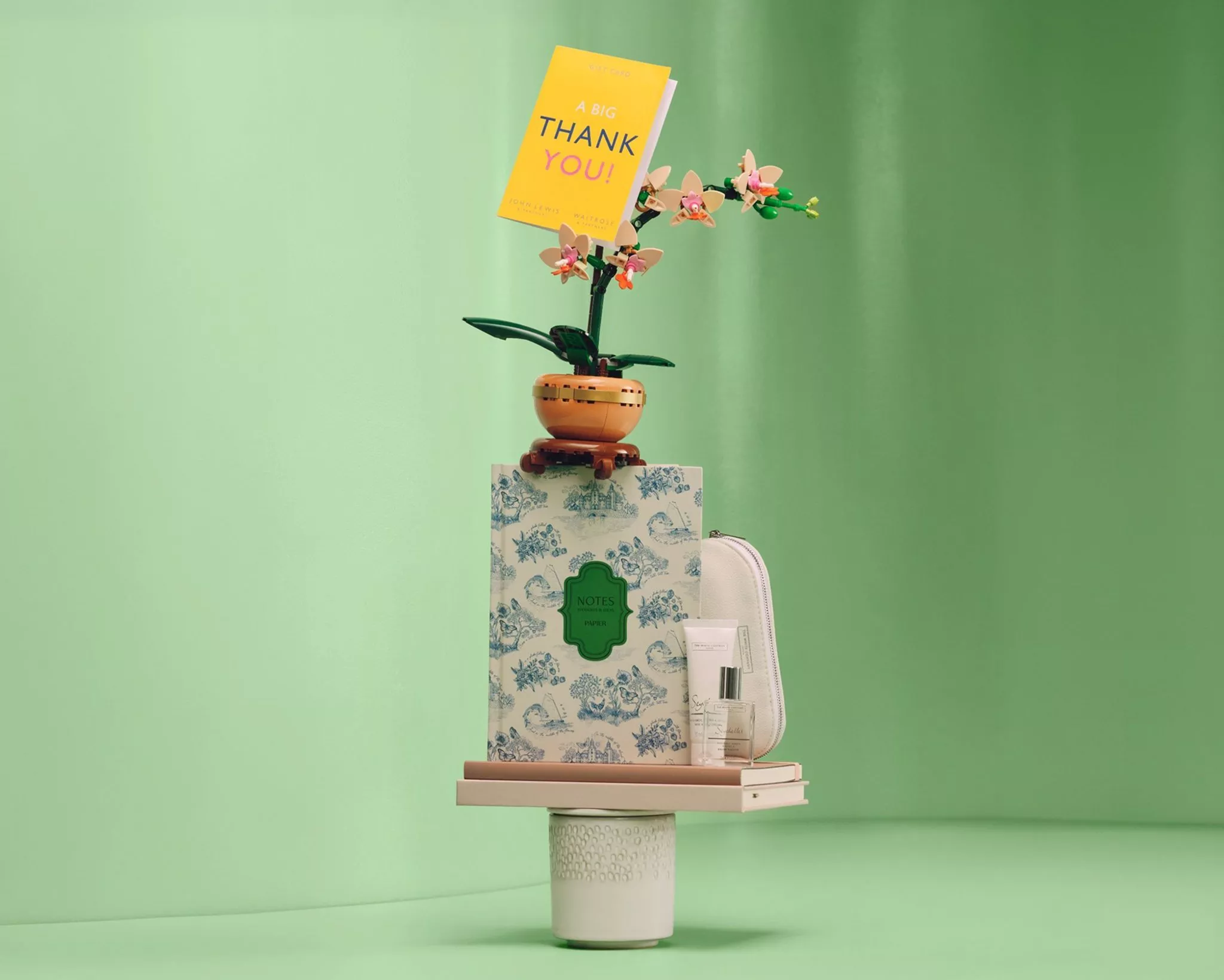 gifts for a teacher stacked ontop of each other on a green background