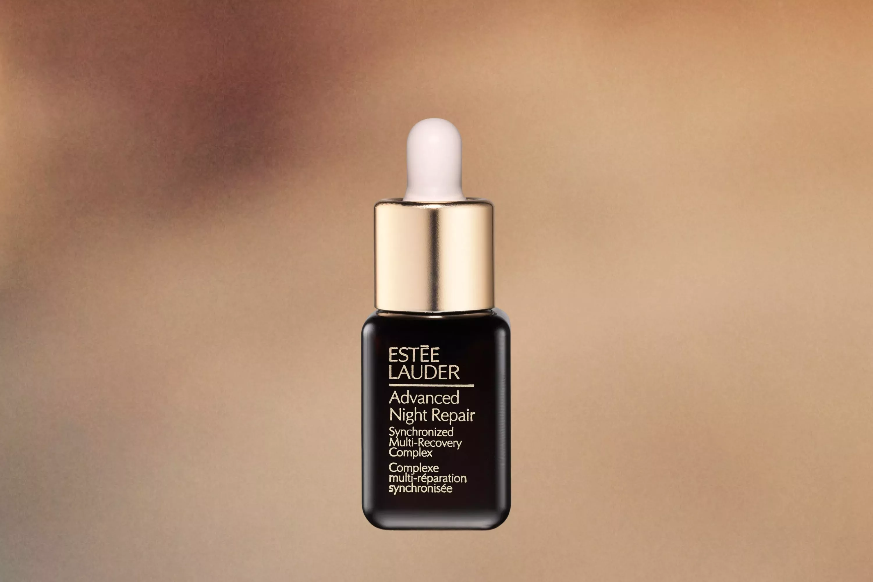 Estée Lauder Advanced Night Repair Serum cutout on a mottled background