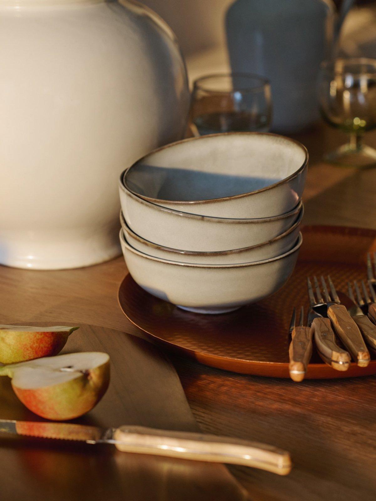 Selection of tableware displayed on a wooden dining table