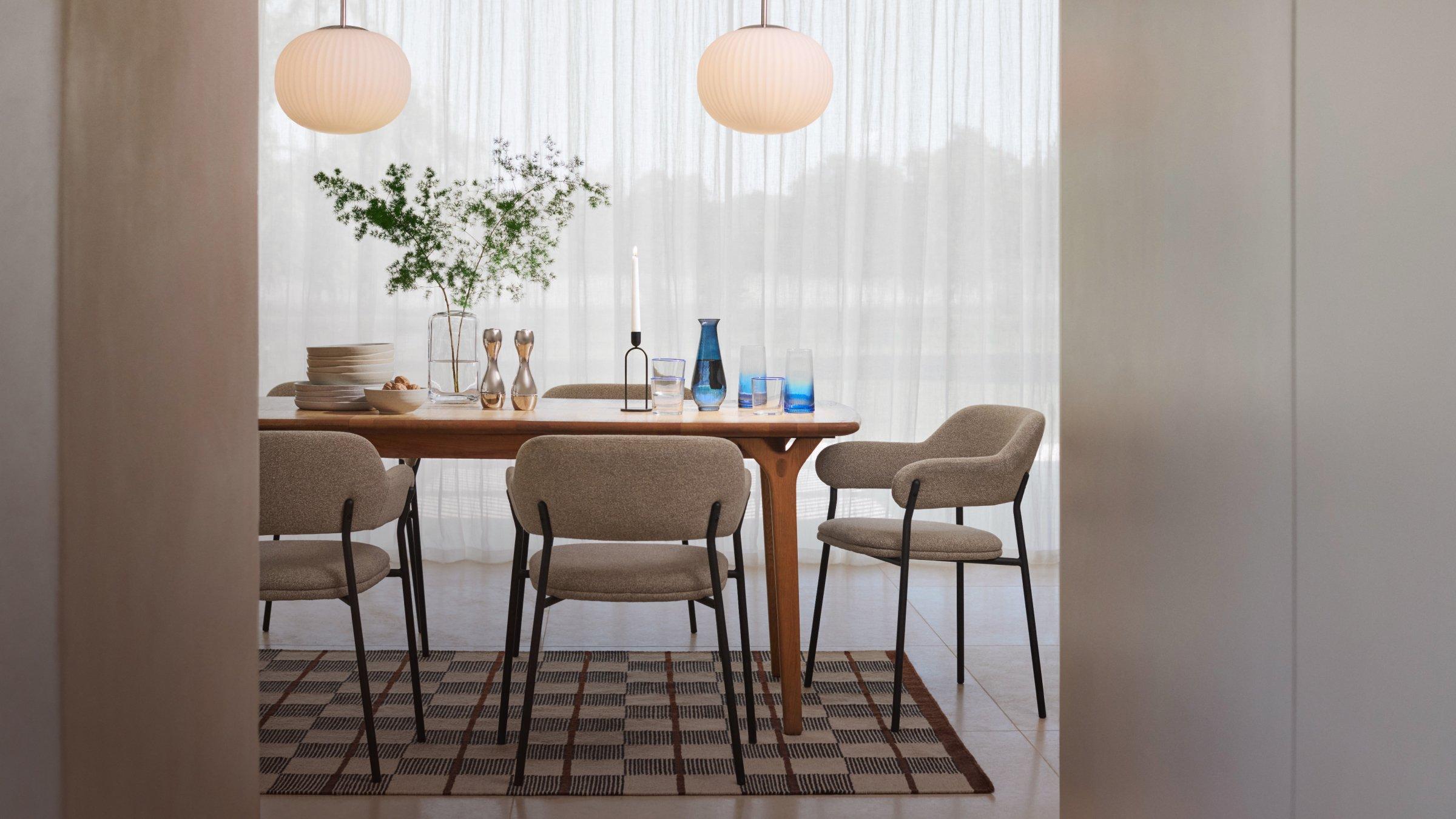 Design Style: Scandi – Crockery and cutlery on a table surrounded by chairs
