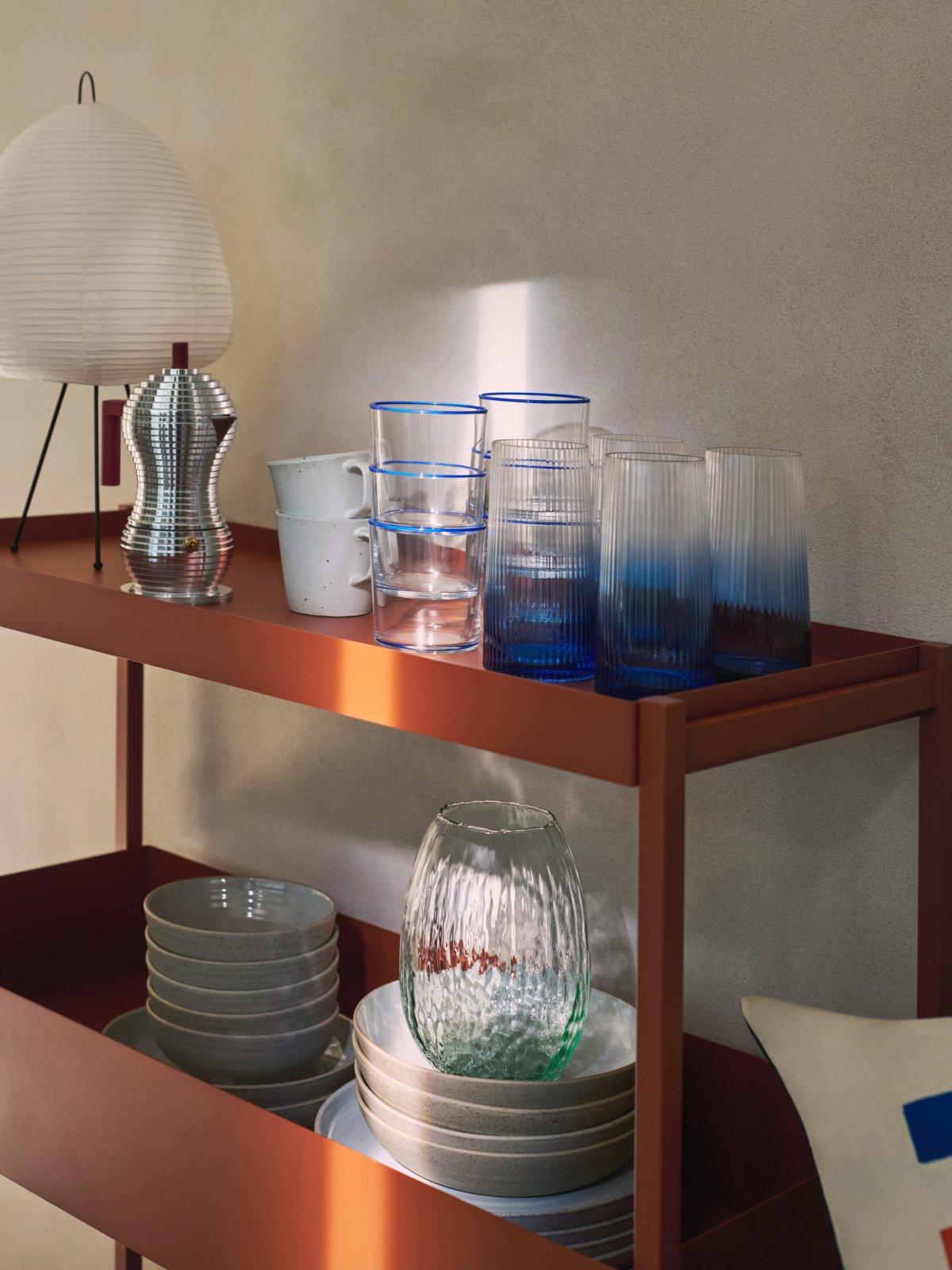 Scandi crockery, expresso maker and lamp stored on a stand-alone shelf unit